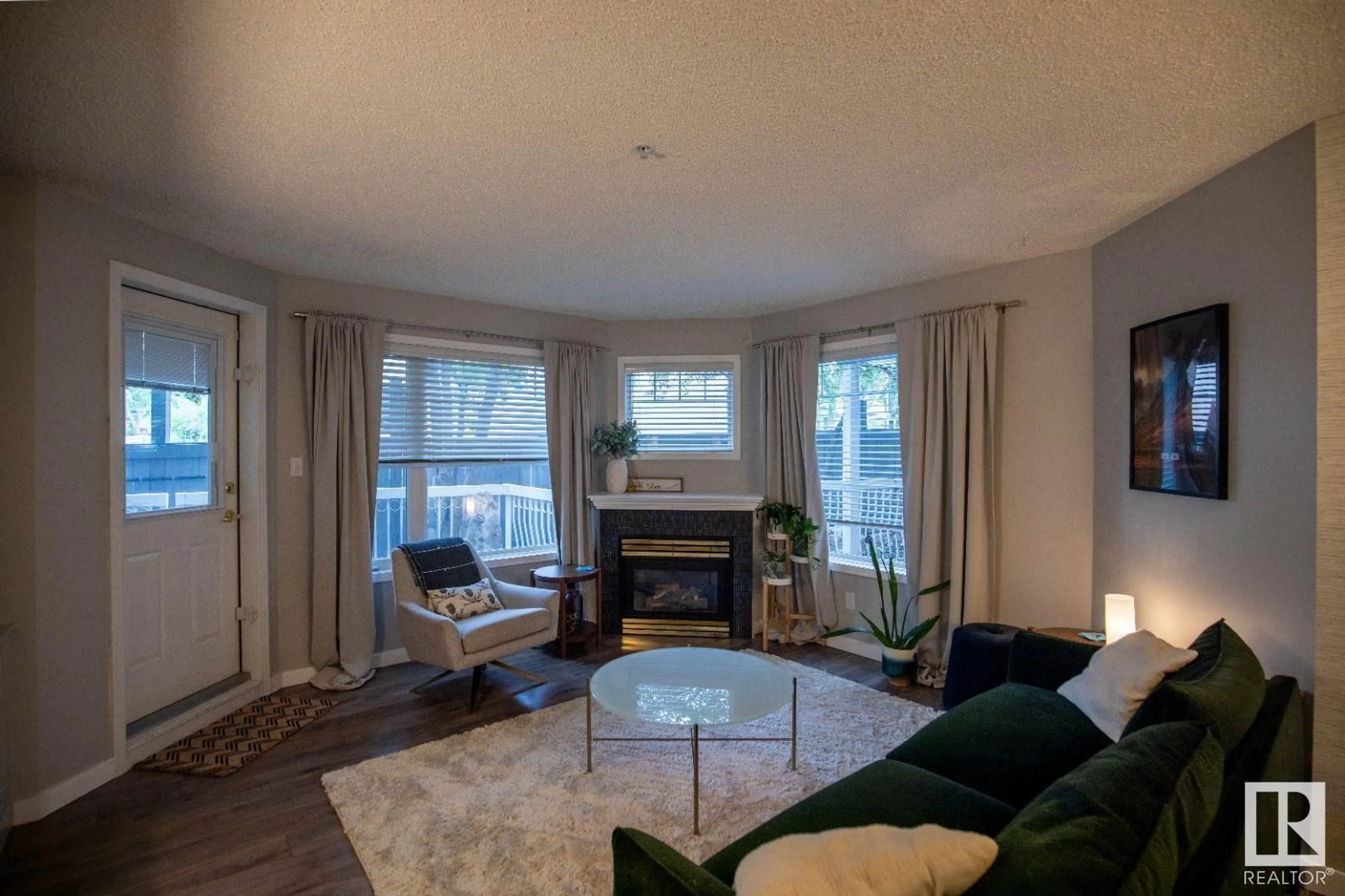 Living room with furniture, wood/laminate floor for #104 - 8909 100 ST, Edmonton Alberta T6E6T4