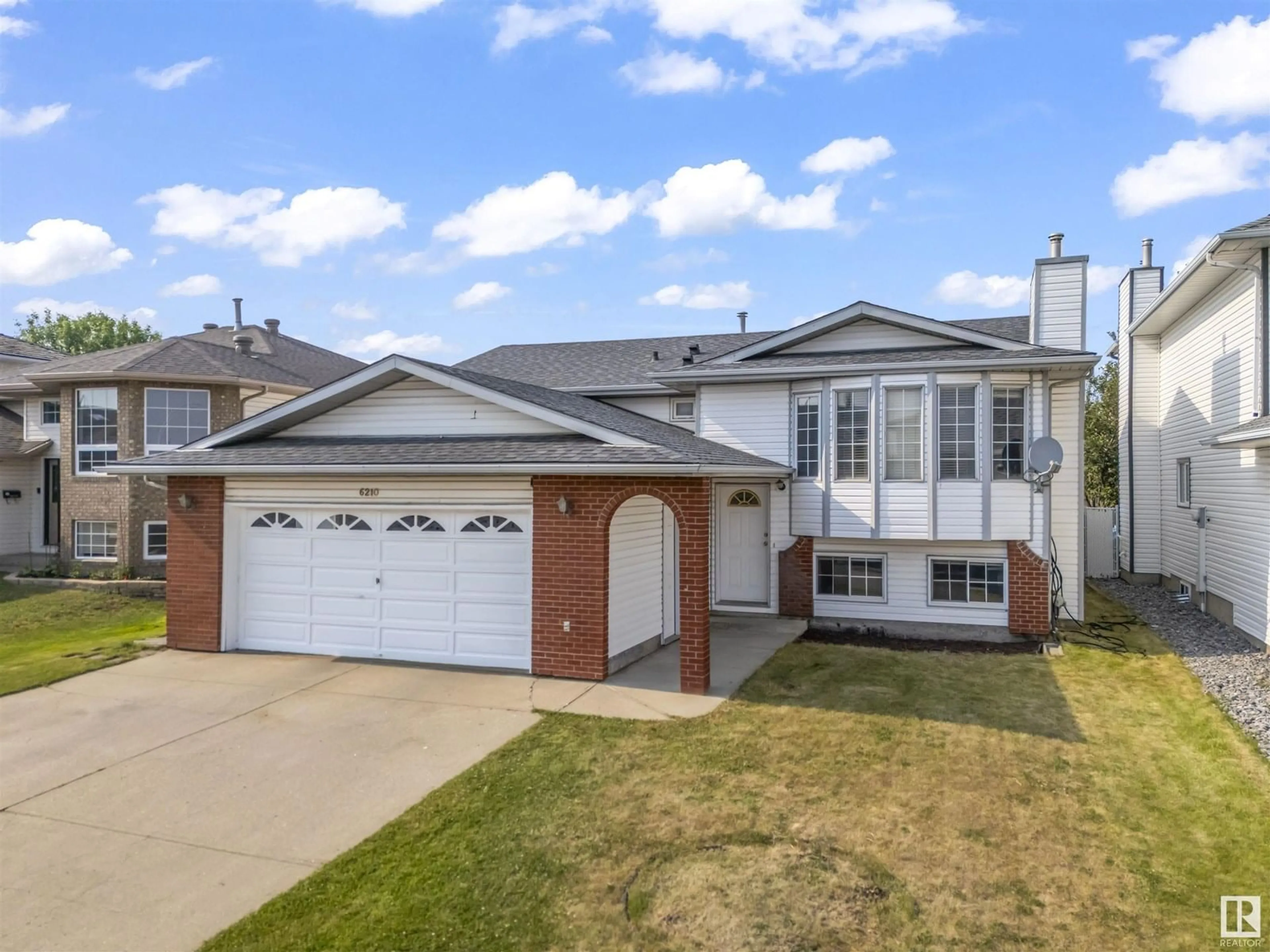 Home with vinyl exterior material, street for 6210 162A AV, Edmonton Alberta T5Y2R2