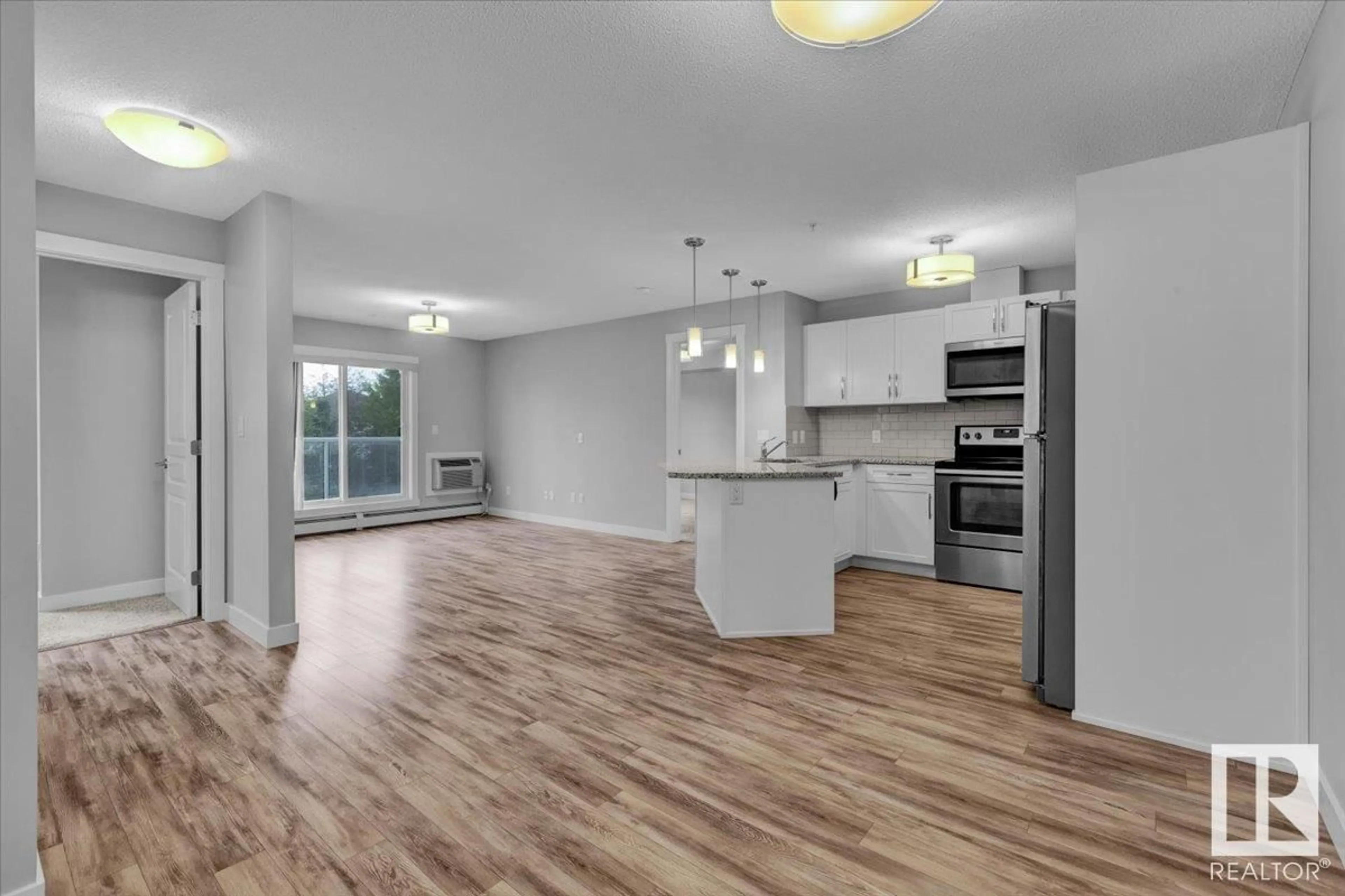 Open concept kitchen, wood/laminate floor for 205 2229 44 AV NW, Edmonton Alberta T6T0W6