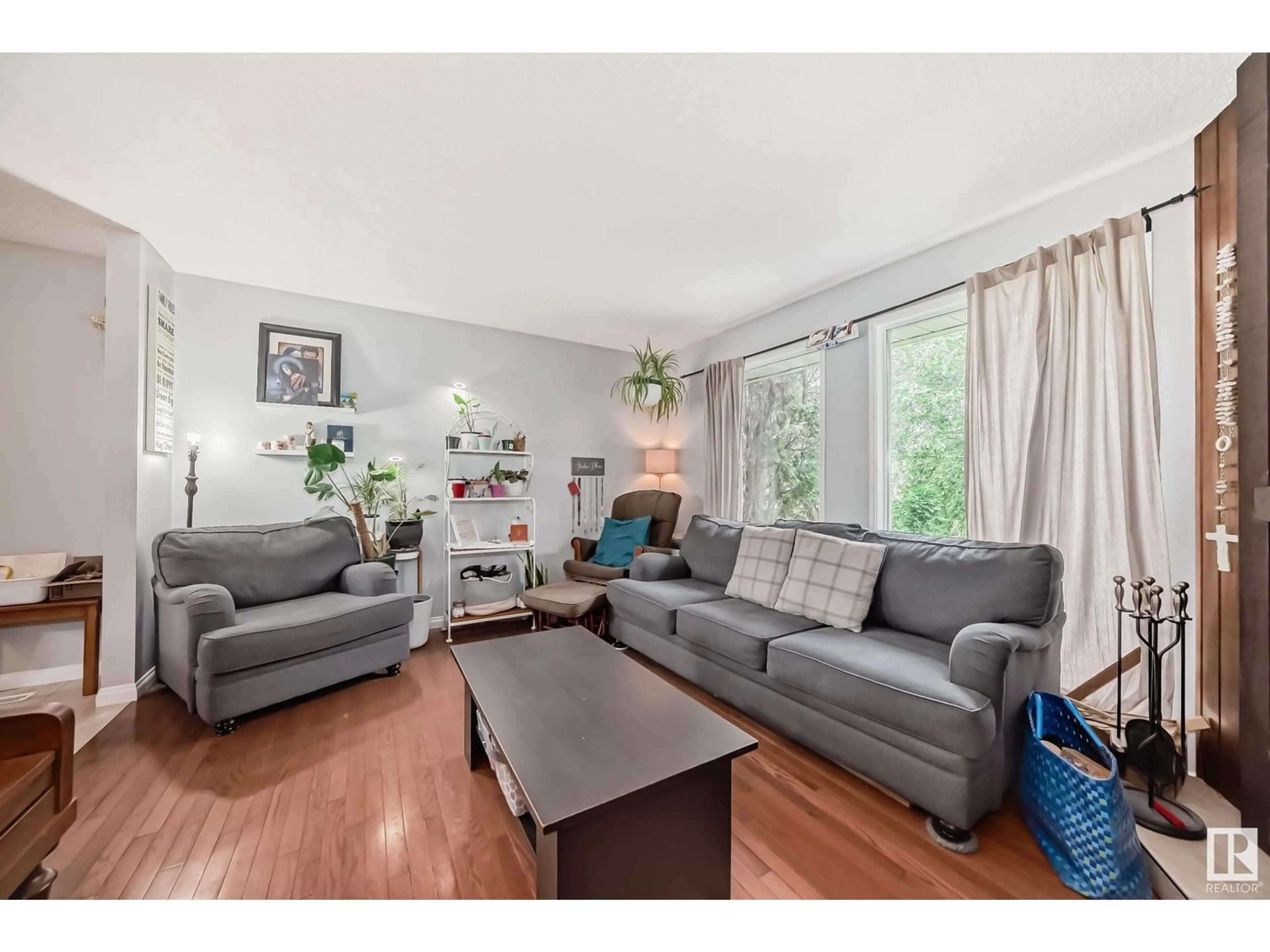 Living room with furniture, wood/laminate floor for NW - 15608 124 ST, Edmonton Alberta T5X2W9
