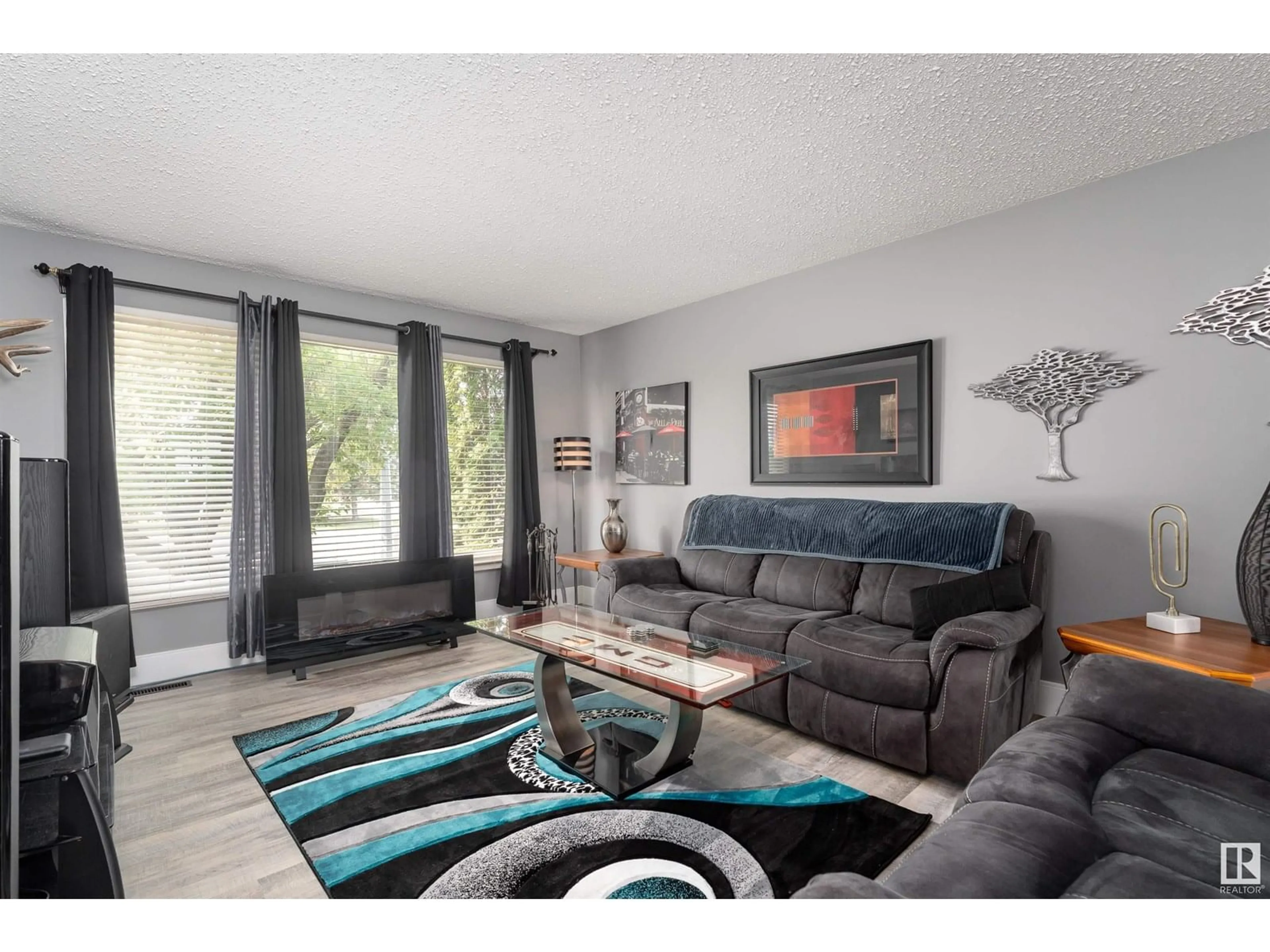 Living room with furniture, wood/laminate floor for 10628 110 ST, Westlock Alberta T7P1A2