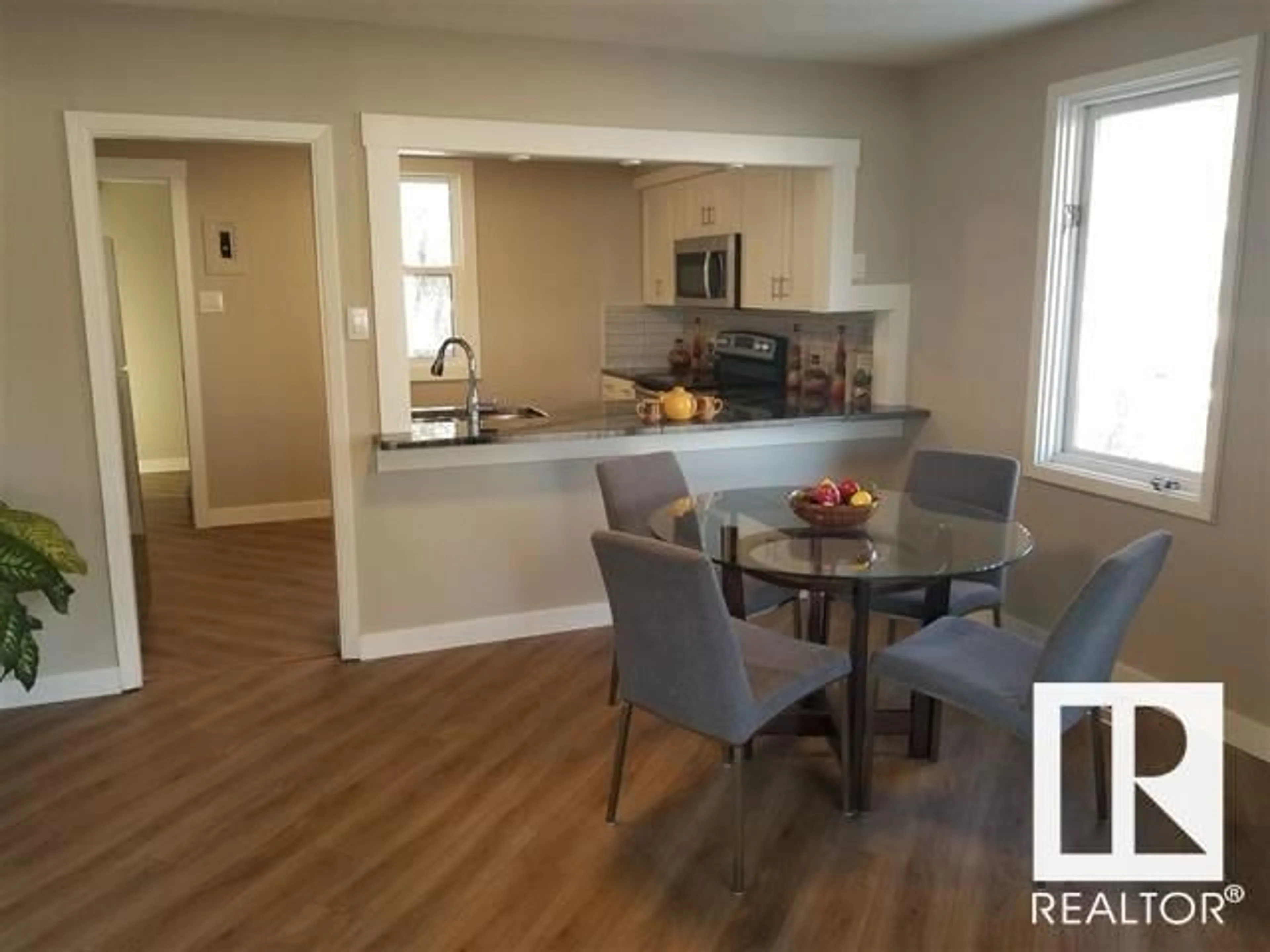 Open concept kitchen, wood/laminate floor for NW - 3848 114 AV, Edmonton Alberta T5W0S7