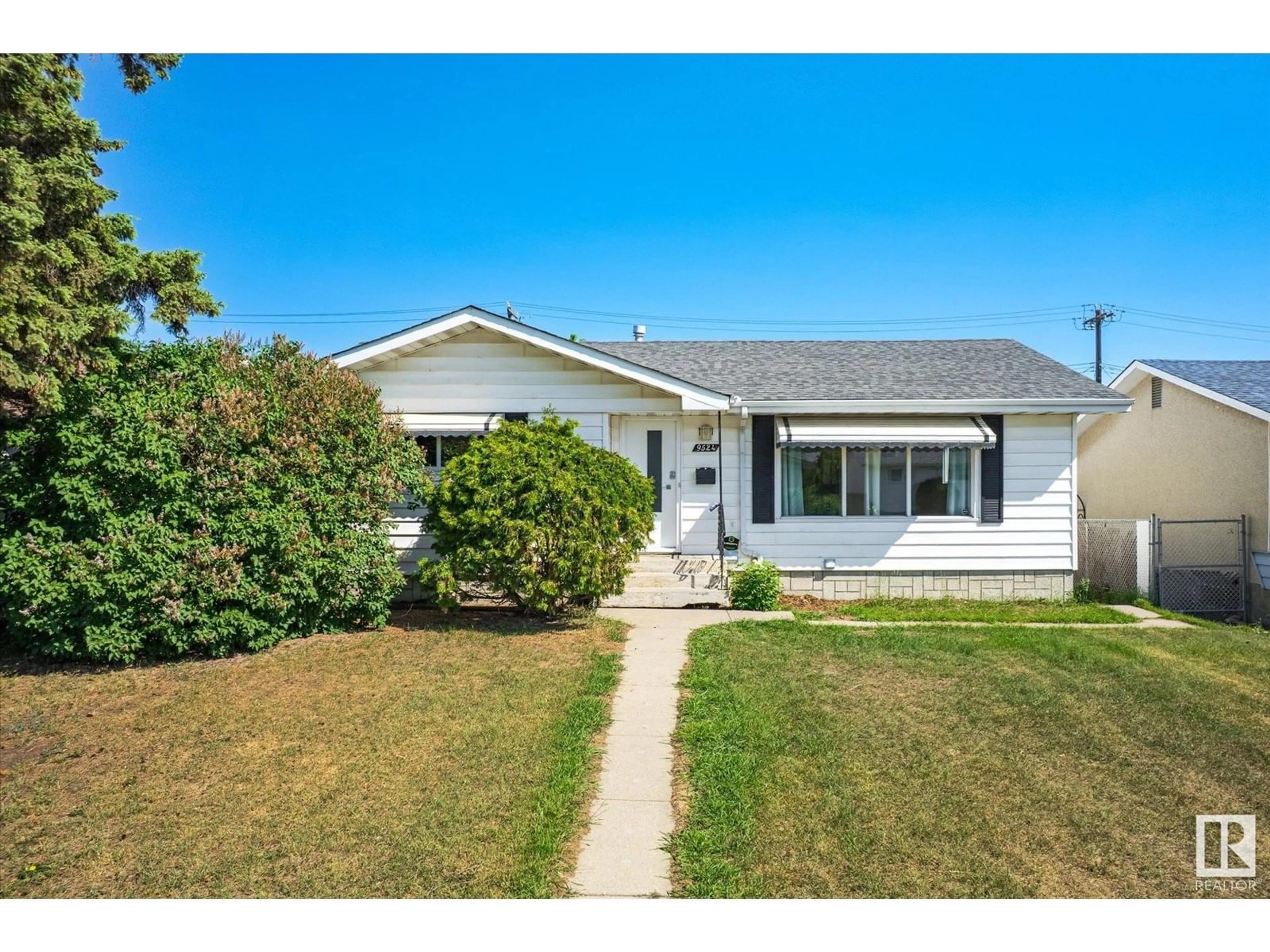 Home with vinyl exterior material, street for 9524 134 AV, Edmonton Alberta T5E1H7