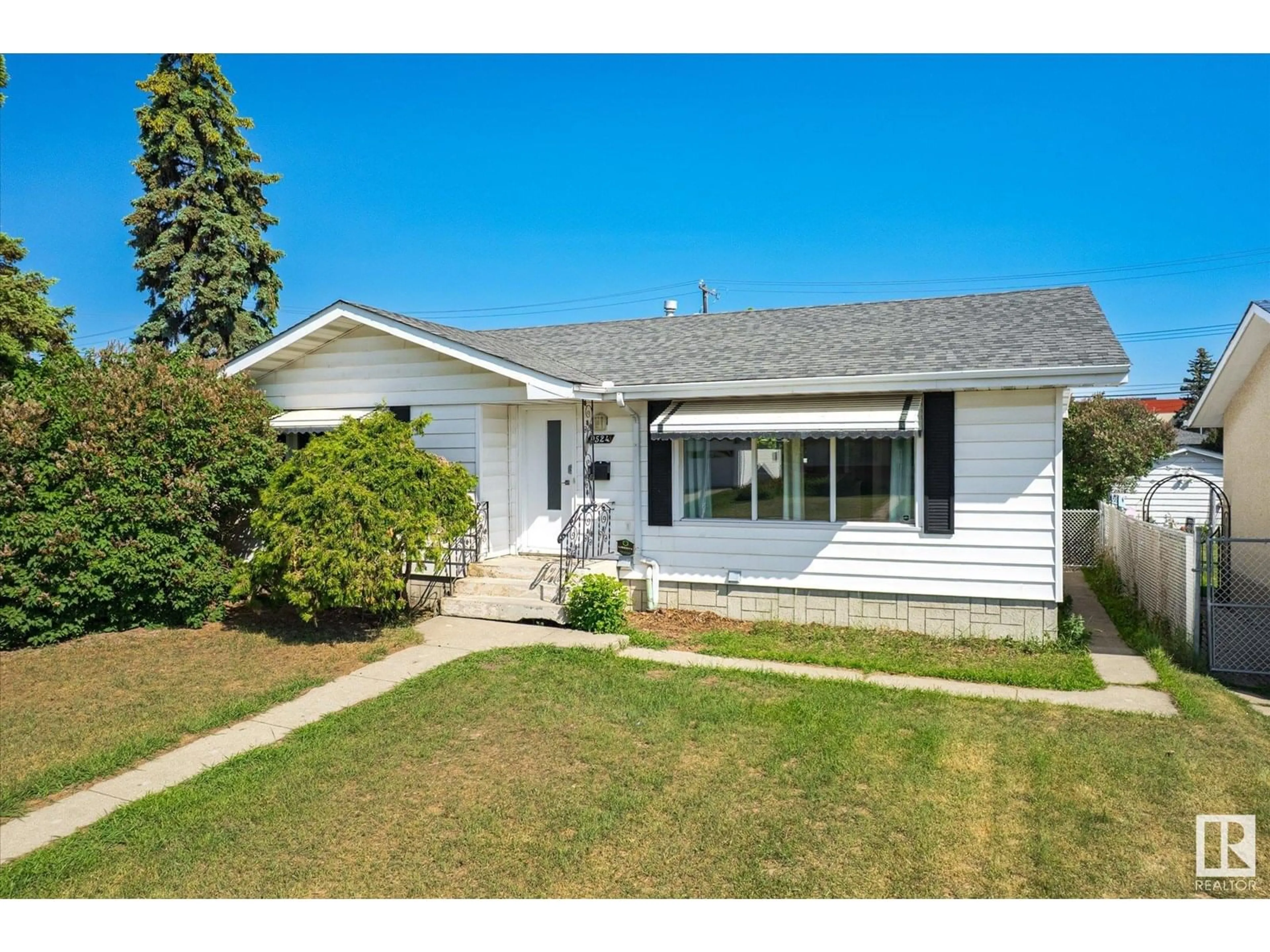 Home with vinyl exterior material, street for 9524 134 AV, Edmonton Alberta T5E1H7