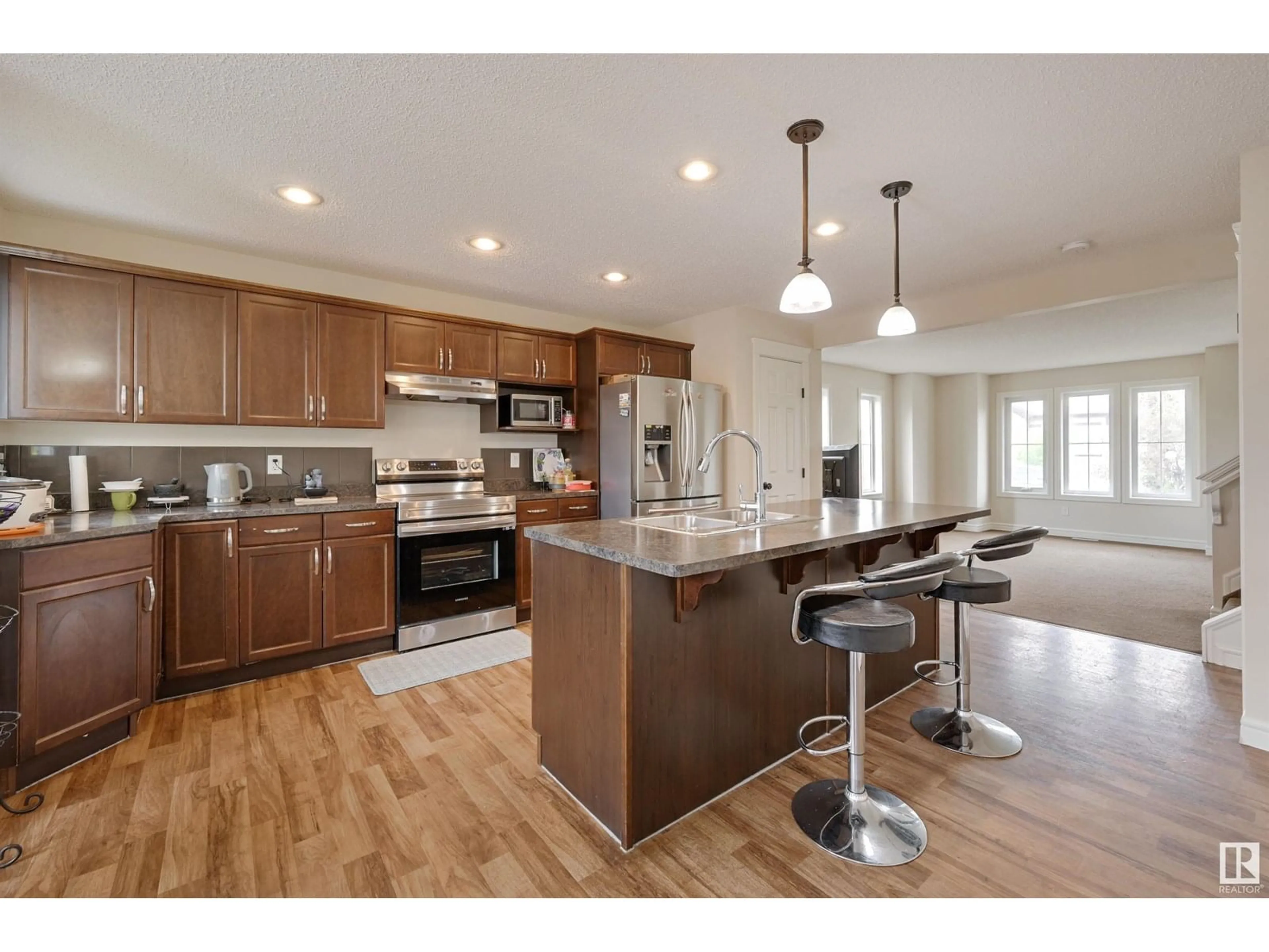 Open concept kitchen, wood/laminate floor for 1807 52 ST, Edmonton Alberta T6X1Y1