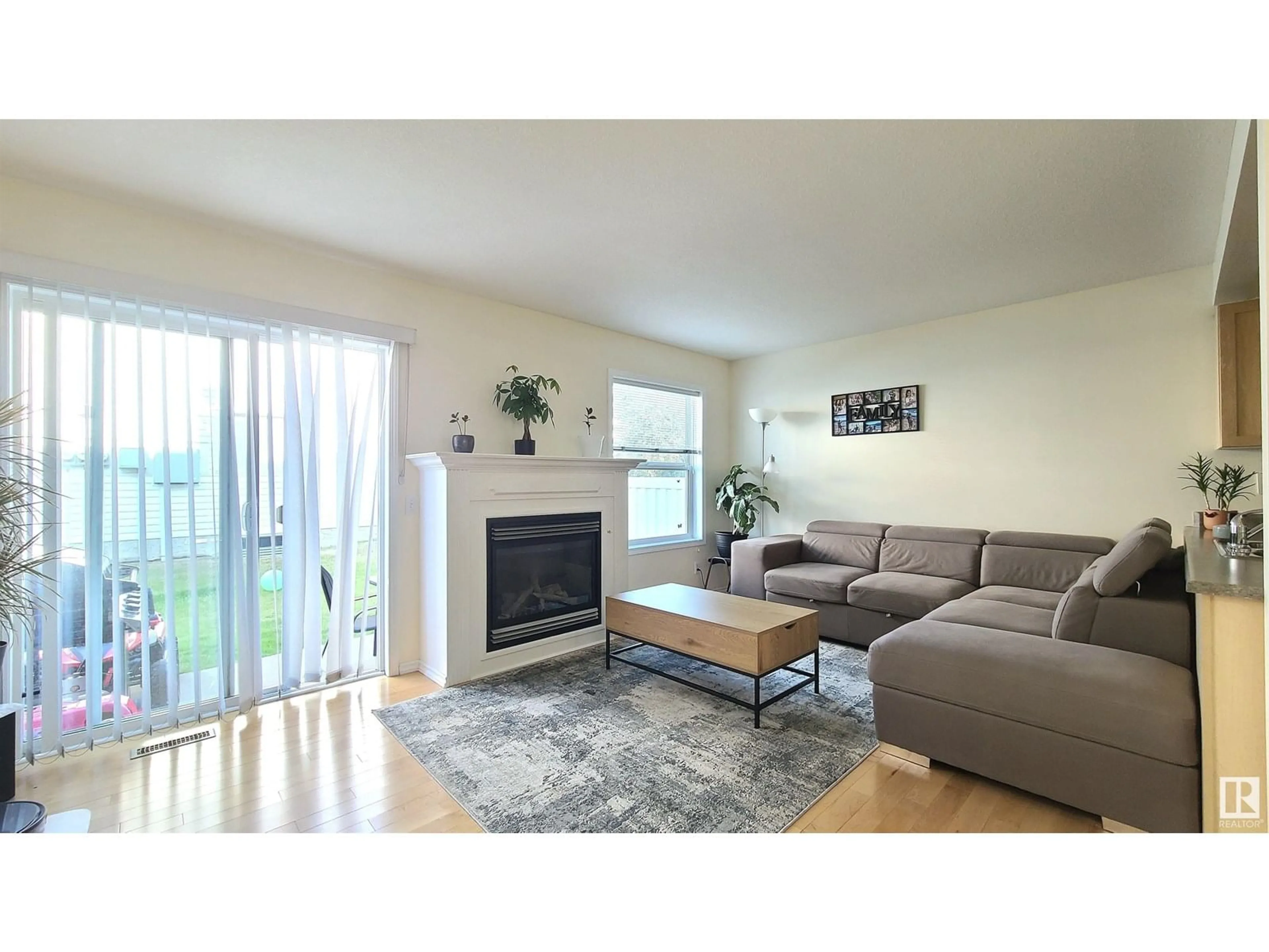 Living room with furniture, wood/laminate floor for 132 16823 84 ST NW, Edmonton Alberta T5Z3S4