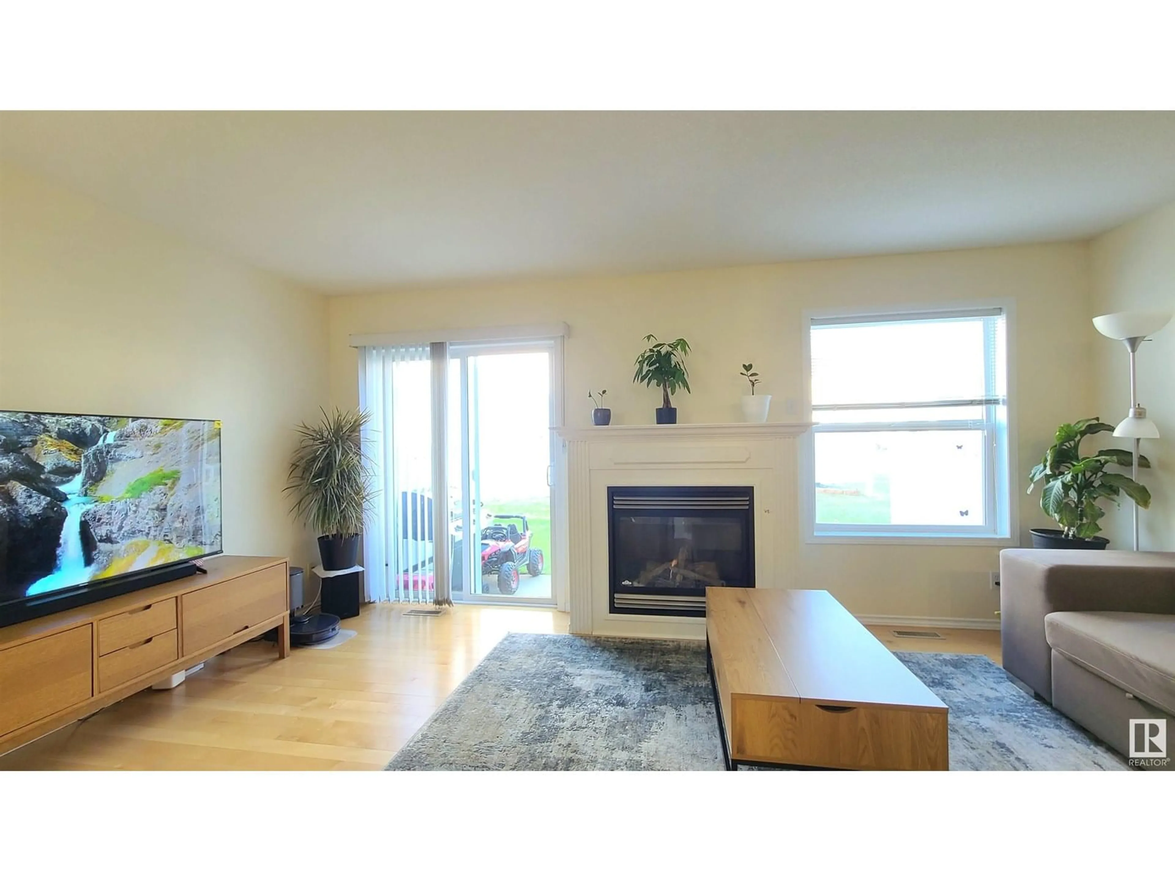 Living room with furniture, wood/laminate floor for 132 16823 84 ST NW, Edmonton Alberta T5Z3S4