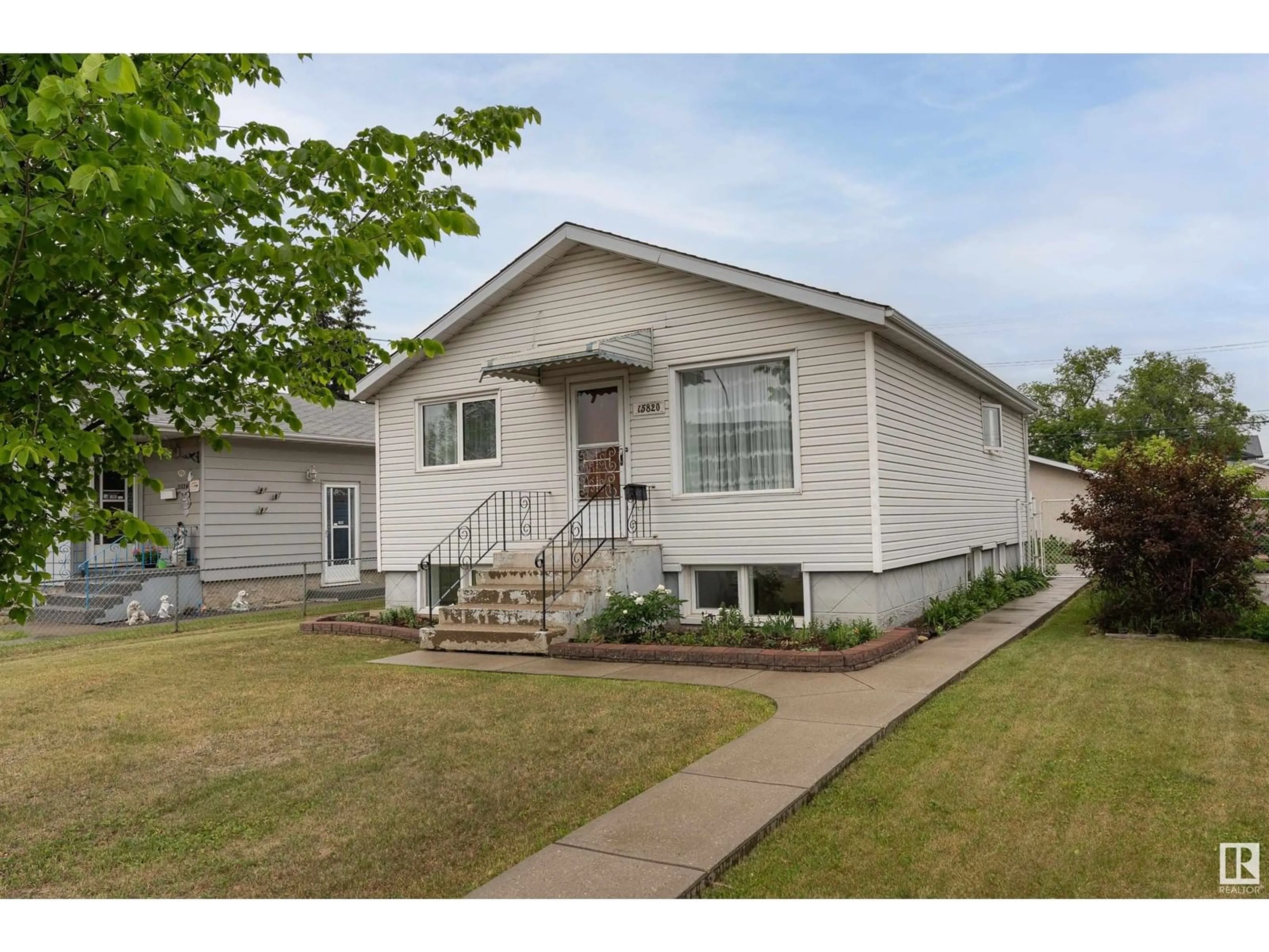 Home with vinyl exterior material, street for 15820 100 AV NW, Edmonton Alberta T5P0L2
