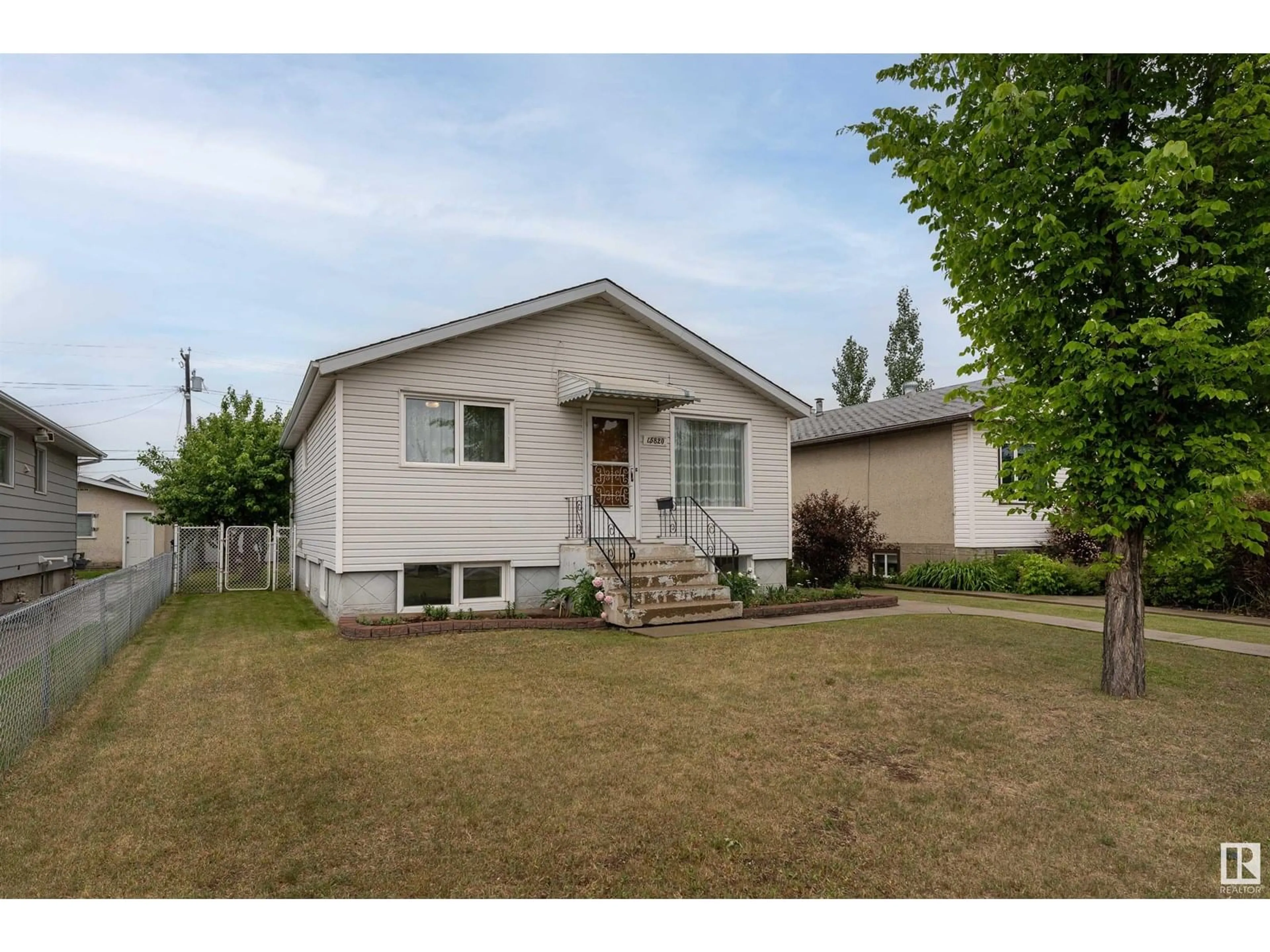 Home with vinyl exterior material, street for 15820 100 AV NW, Edmonton Alberta T5P0L2