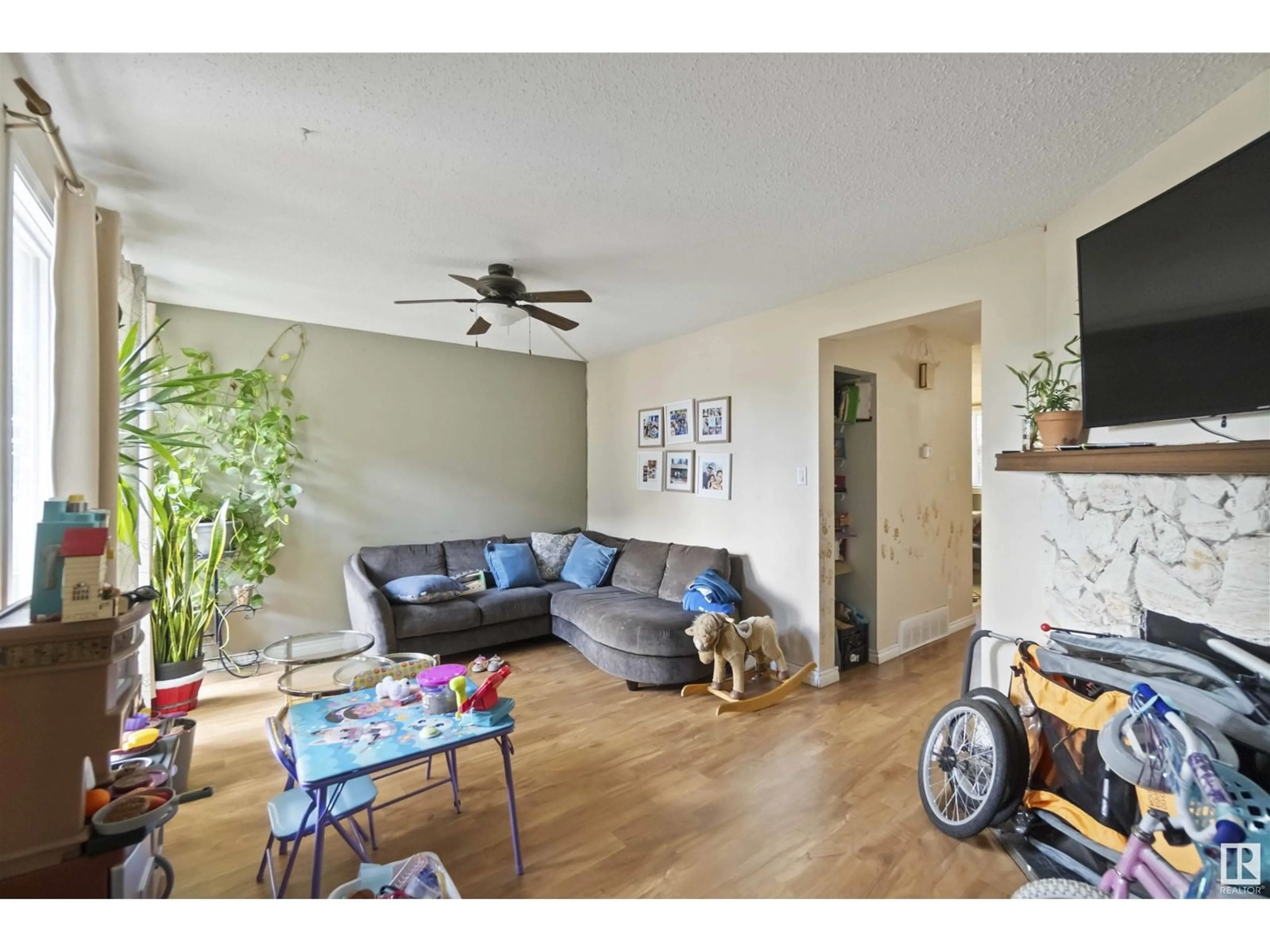 Living room with furniture, wood/laminate floor for NW - 113 10633 AV, Edmonton Alberta T6J4N4