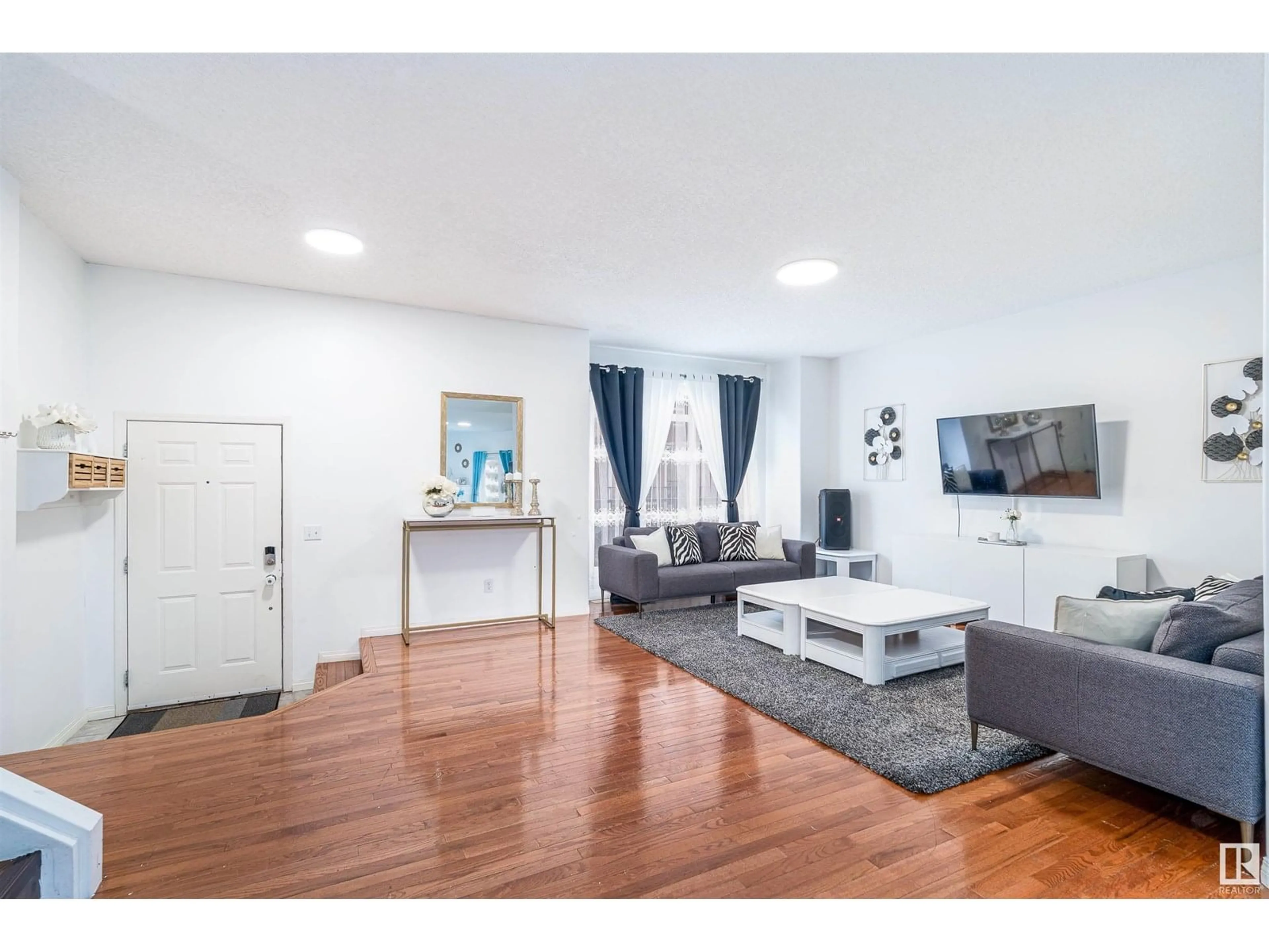 Living room with furniture, wood/laminate floor for 8403 - 19 164 AV, Edmonton Alberta T5Z3Y2