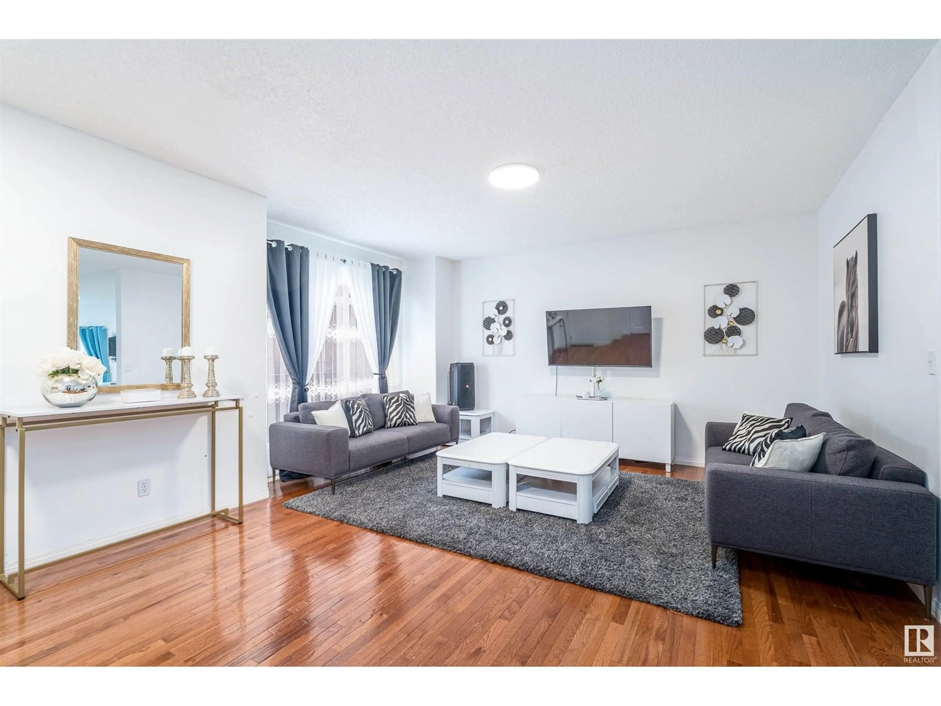 Living room with furniture, wood/laminate floor for 8403 - 19 164 AV, Edmonton Alberta T5Z3Y2
