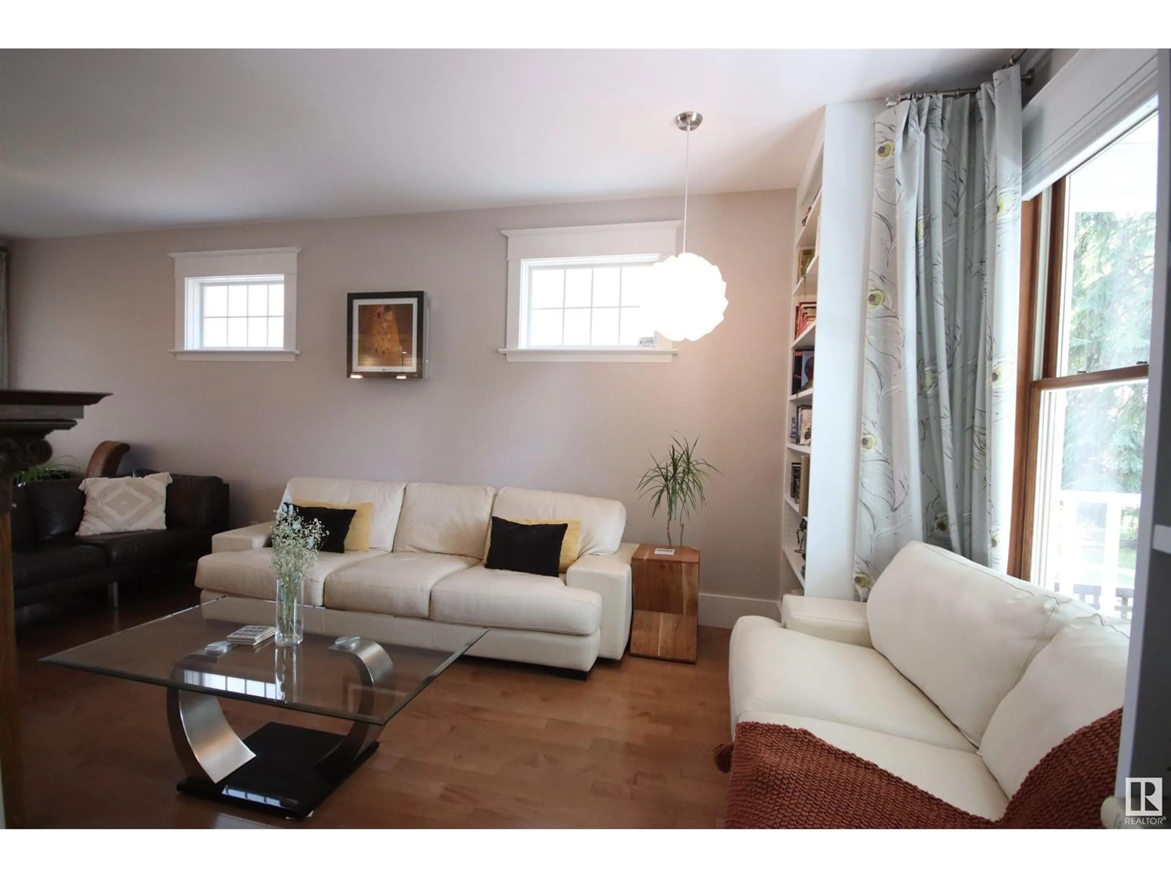 Living room with furniture, wood/laminate floor for 10944 89 AV, Edmonton Alberta T6G0Z5