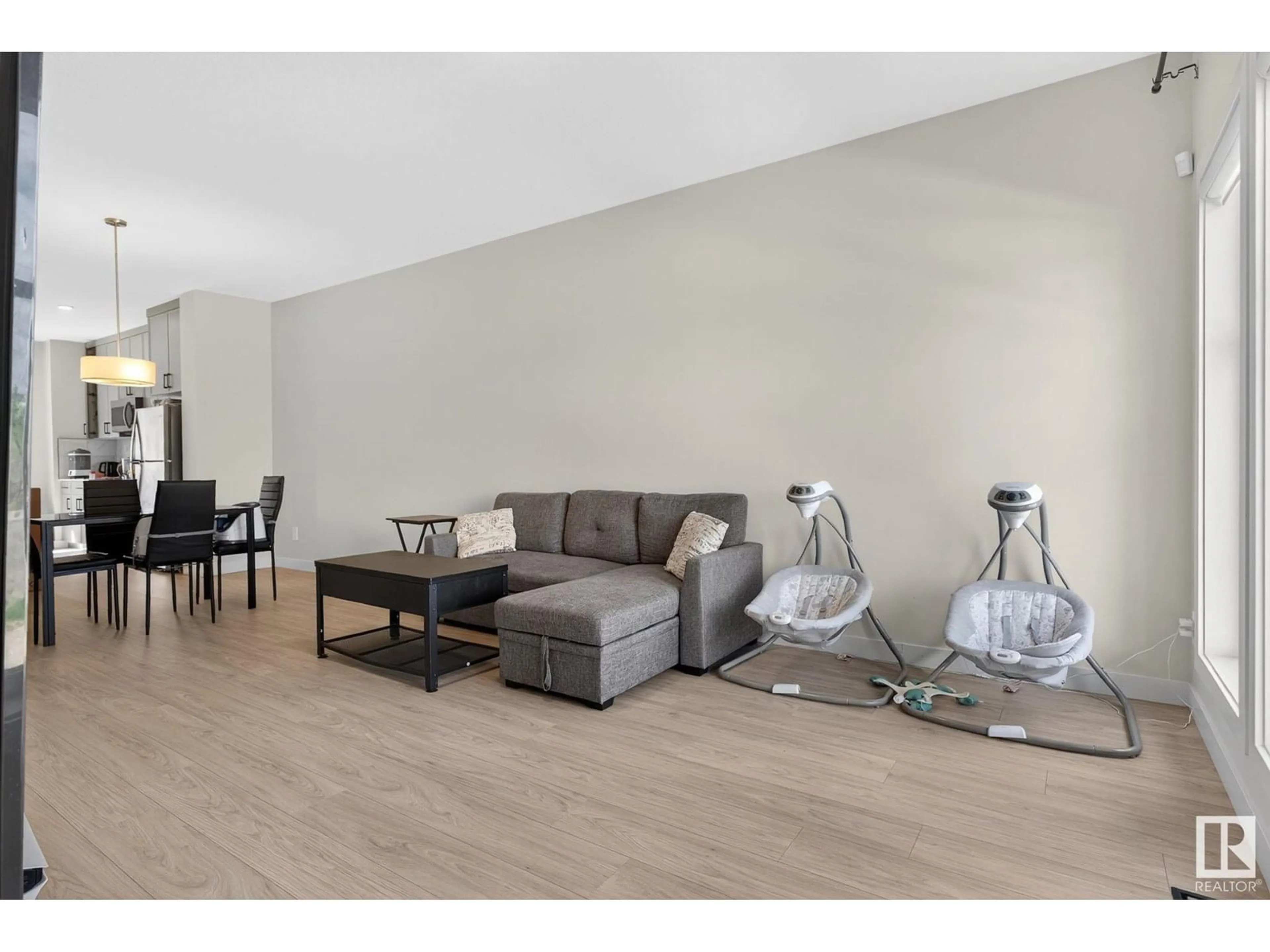 Living room with furniture, wood/laminate floor for NW - 7133 178 AV, Edmonton Alberta T5Z0T8