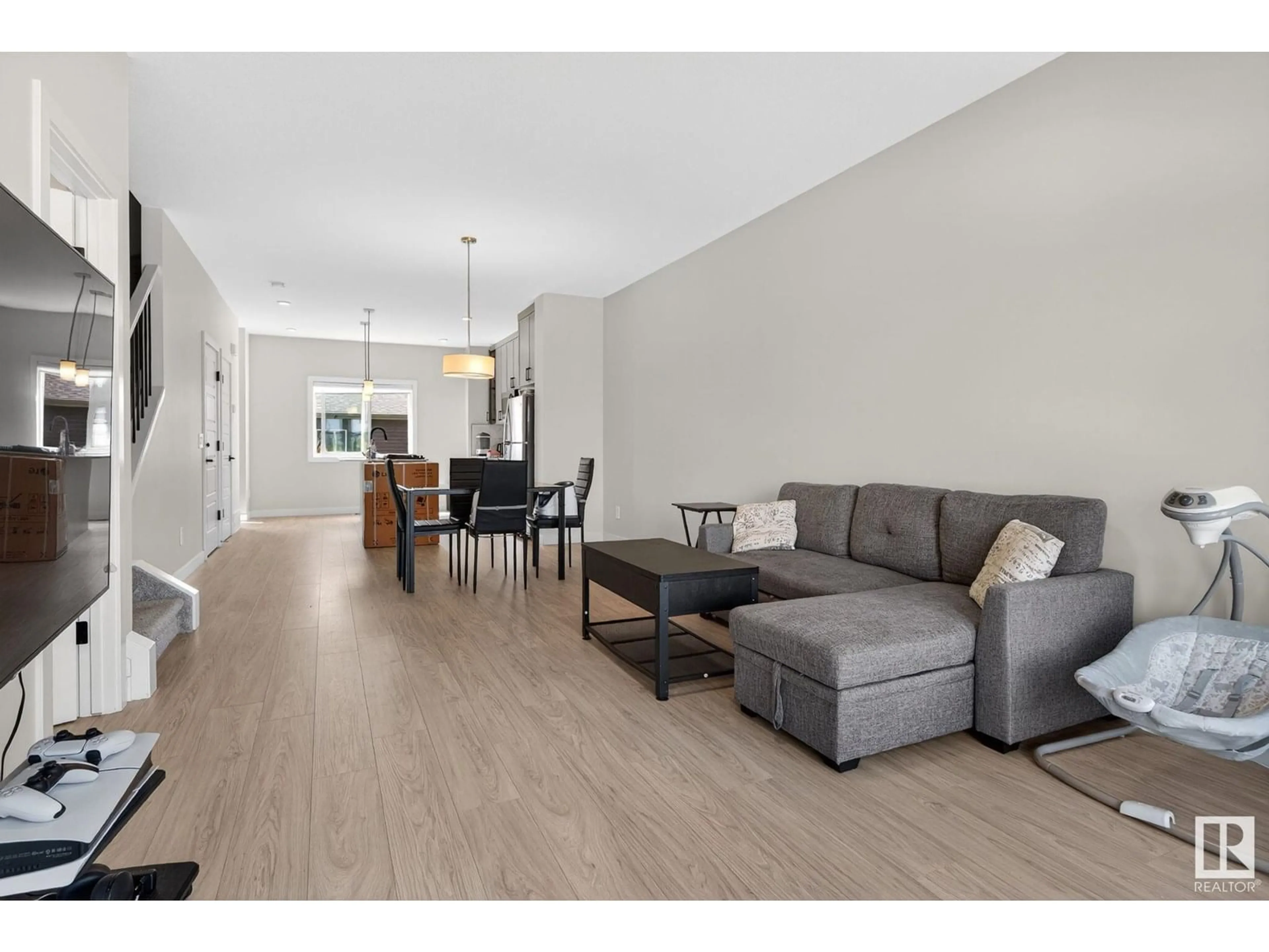 Living room with furniture, wood/laminate floor for NW - 7133 178 AV, Edmonton Alberta T5Z0T8