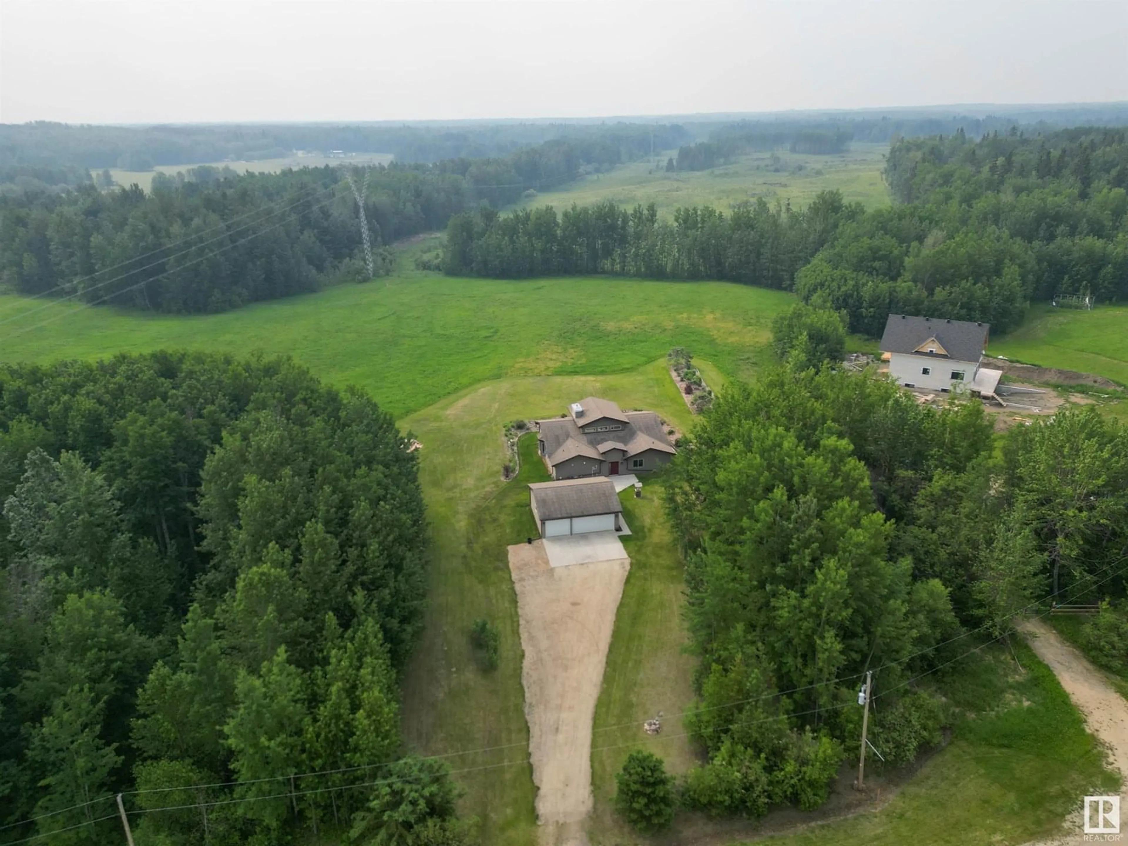 A pic from outside/outdoor area/front of a property/back of a property/a pic from drone, water/lake/river/ocean view for 4021 - 27 TWP ROAD 540, Rural Lac Ste. Anne County Alberta T0E0A1