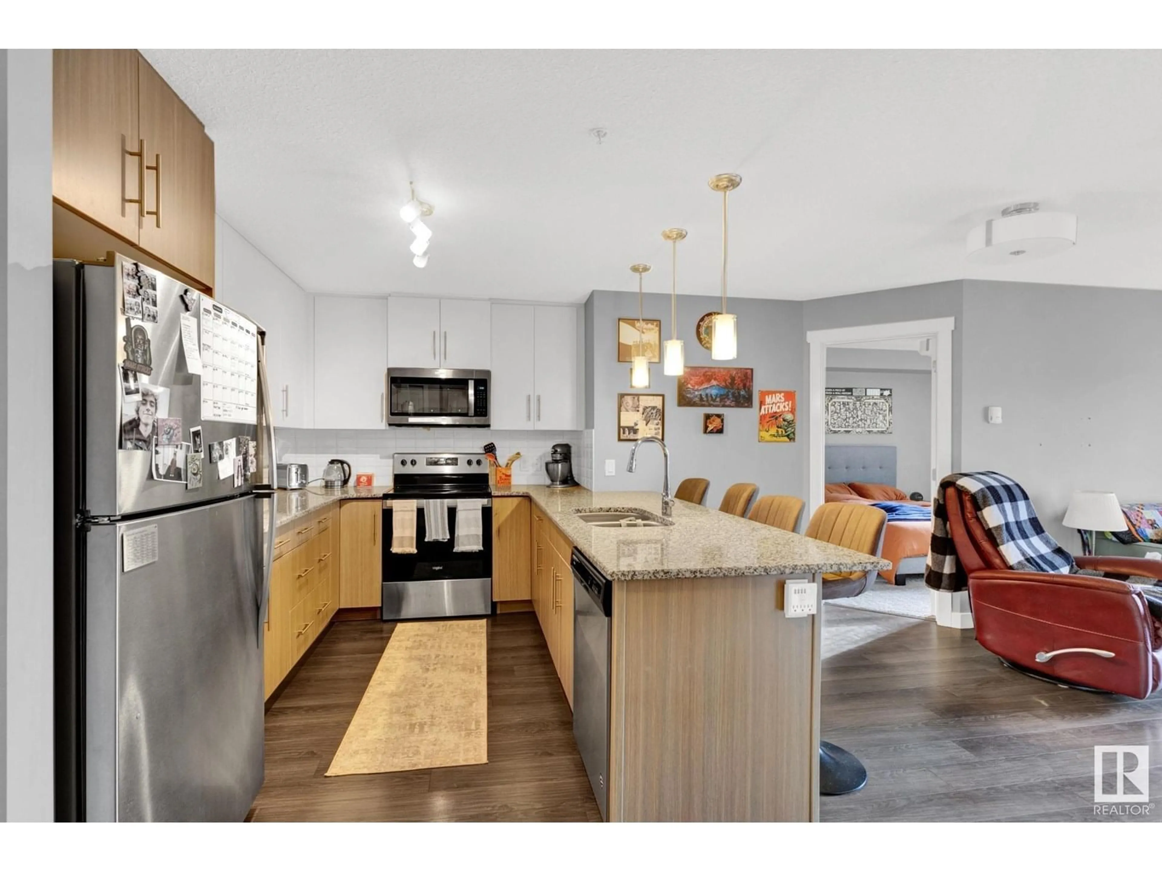 Open concept kitchen, wood/laminate floor for #305 - 3670 139 AV NW, Edmonton Alberta T5Y3N5