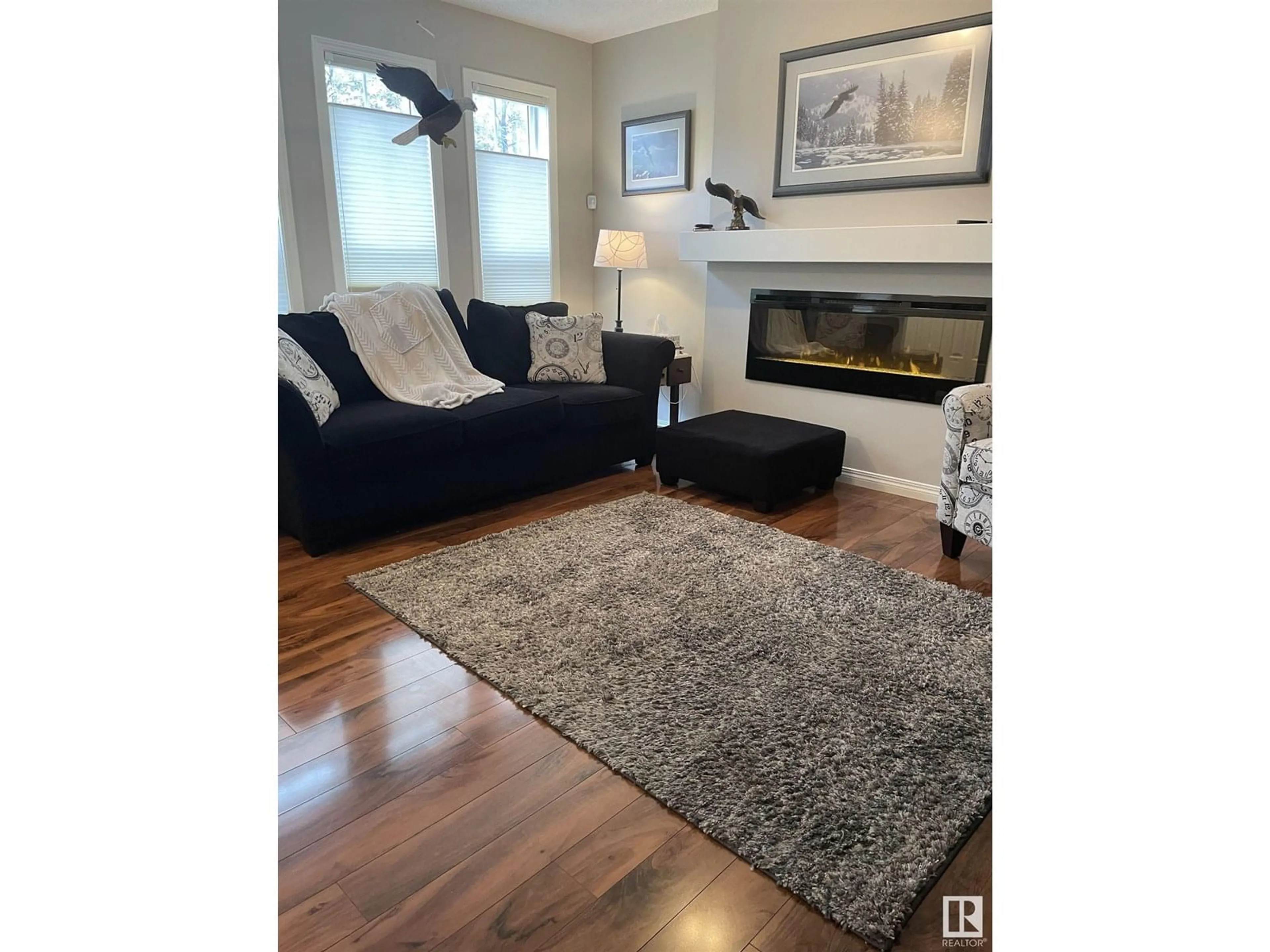 Living room with furniture, wood/laminate floor for SW - 7107 22 AV, Edmonton Alberta T6X0T8