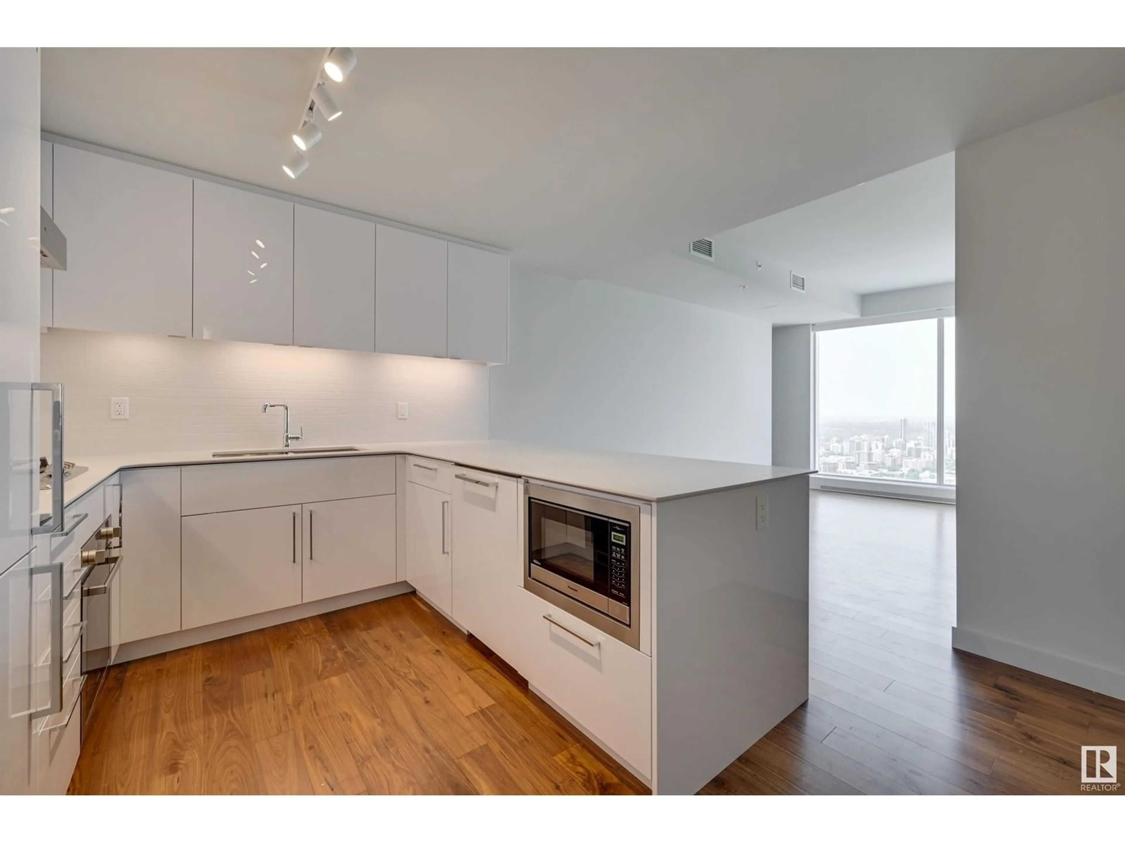 Open concept kitchen, wood/laminate floor for 10360 - 4207 102 ST NW, Edmonton Alberta T5J0K6
