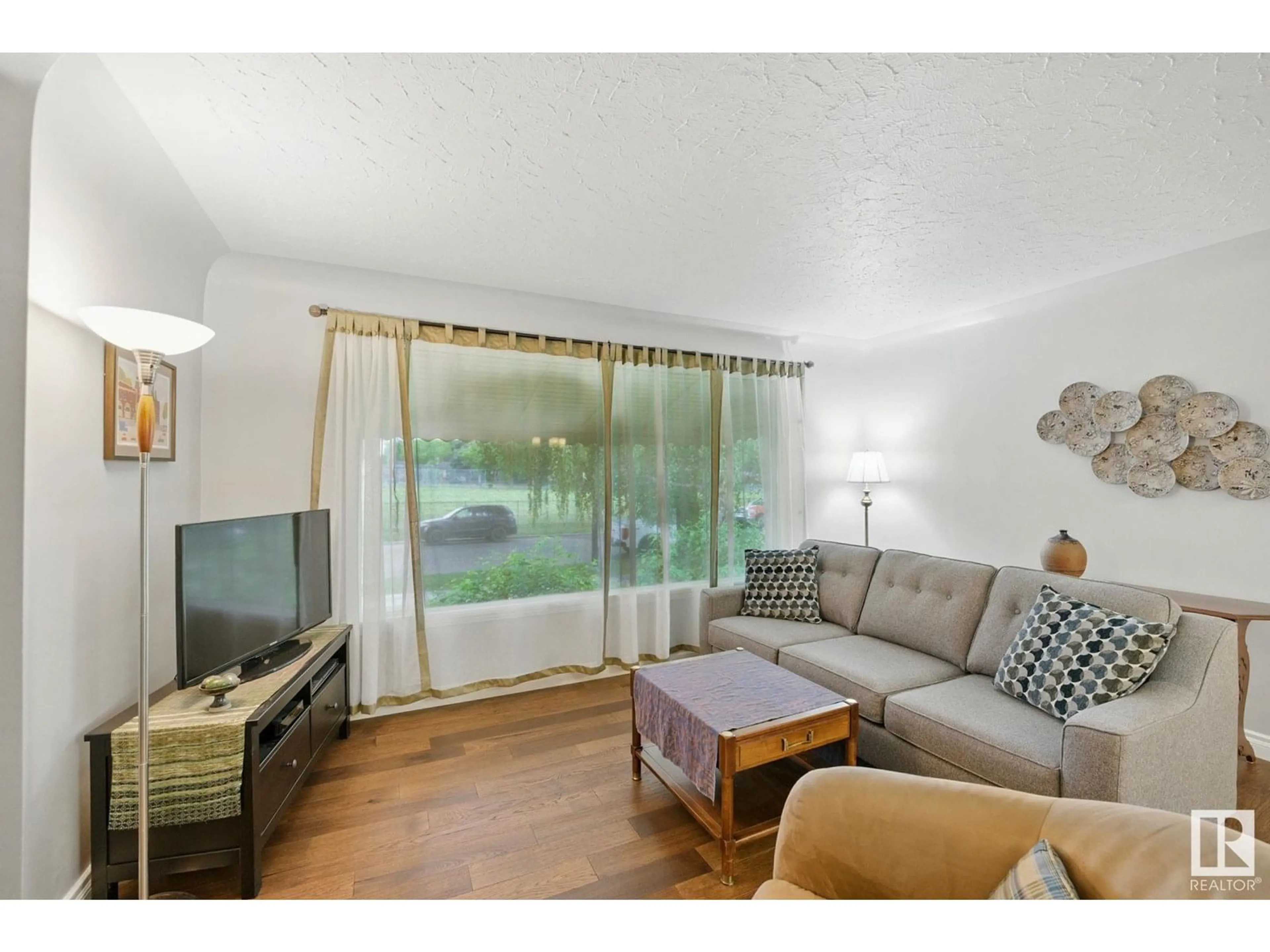 Living room with furniture, wood/laminate floor for 11643 137 ST, Edmonton Alberta T5M1N8