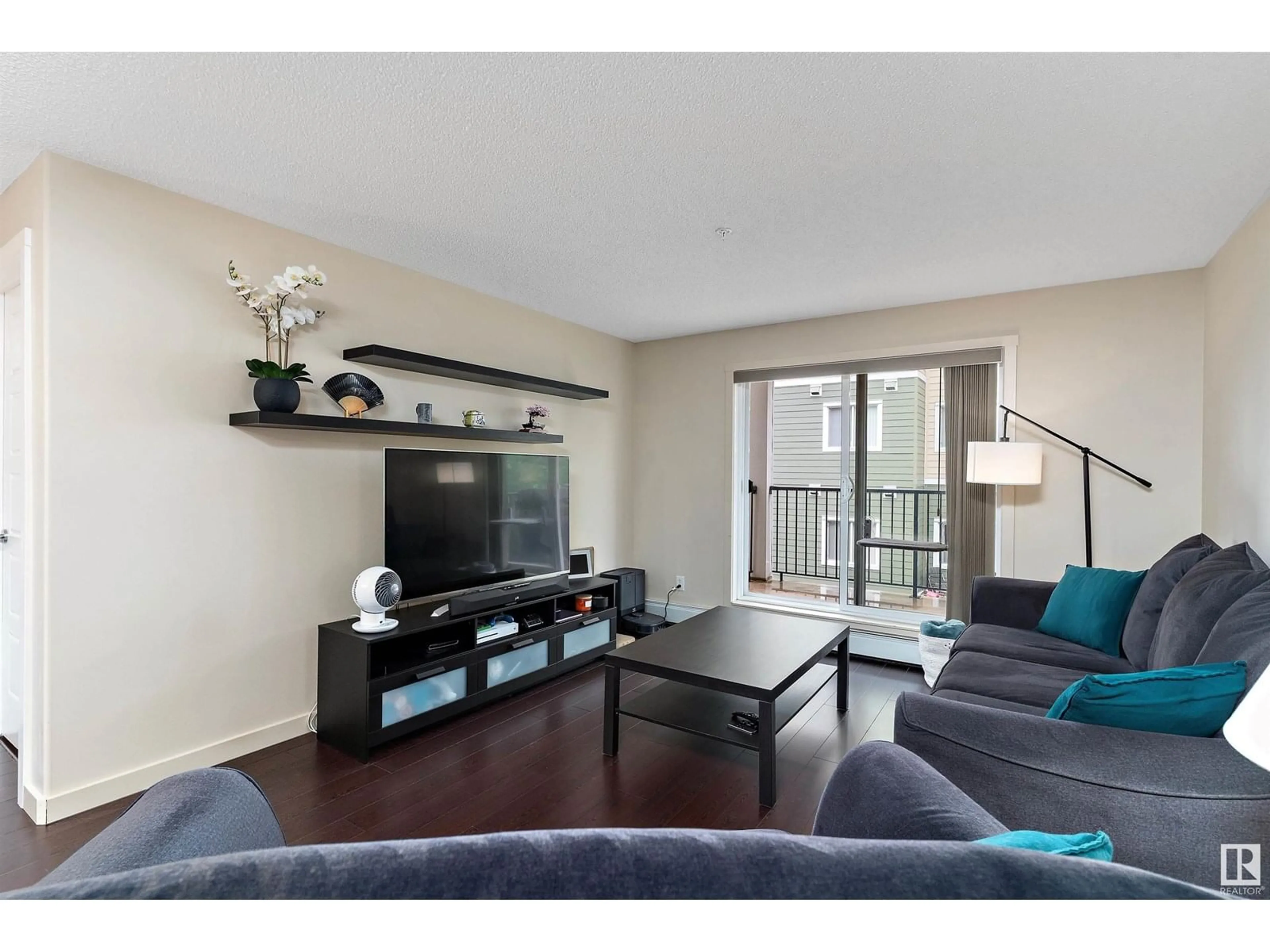 Living room with furniture, wood/laminate floor for 6076 - 238 SCHONSEE WY, Edmonton Alberta T5Z0K8