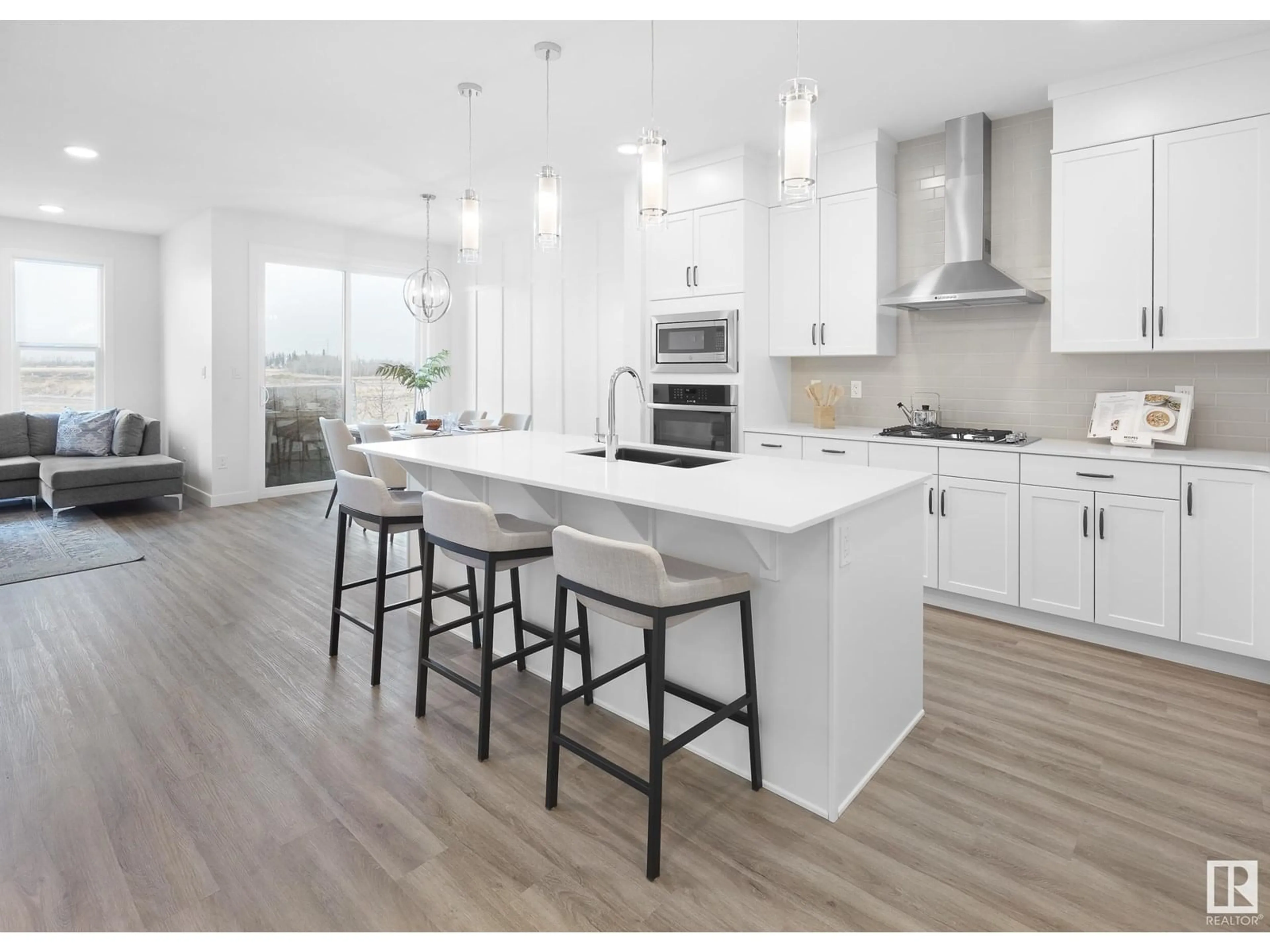 Open concept kitchen, wood/laminate floor for SW - 703 PAYIPWAT CM, Edmonton Alberta T6W5K8