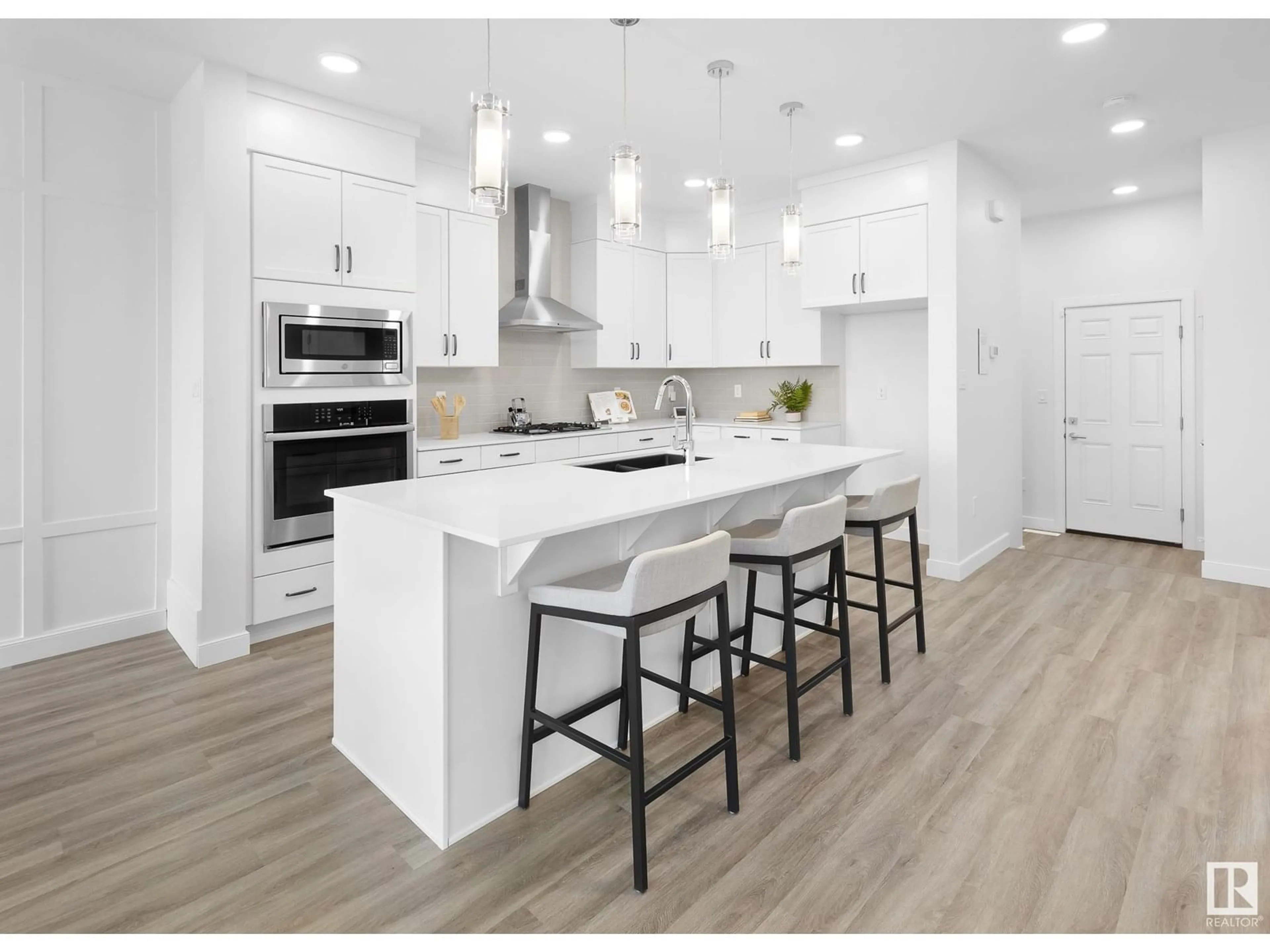 Open concept kitchen, wood/laminate floor for SW - 703 PAYIPWAT CM, Edmonton Alberta T6W5K8
