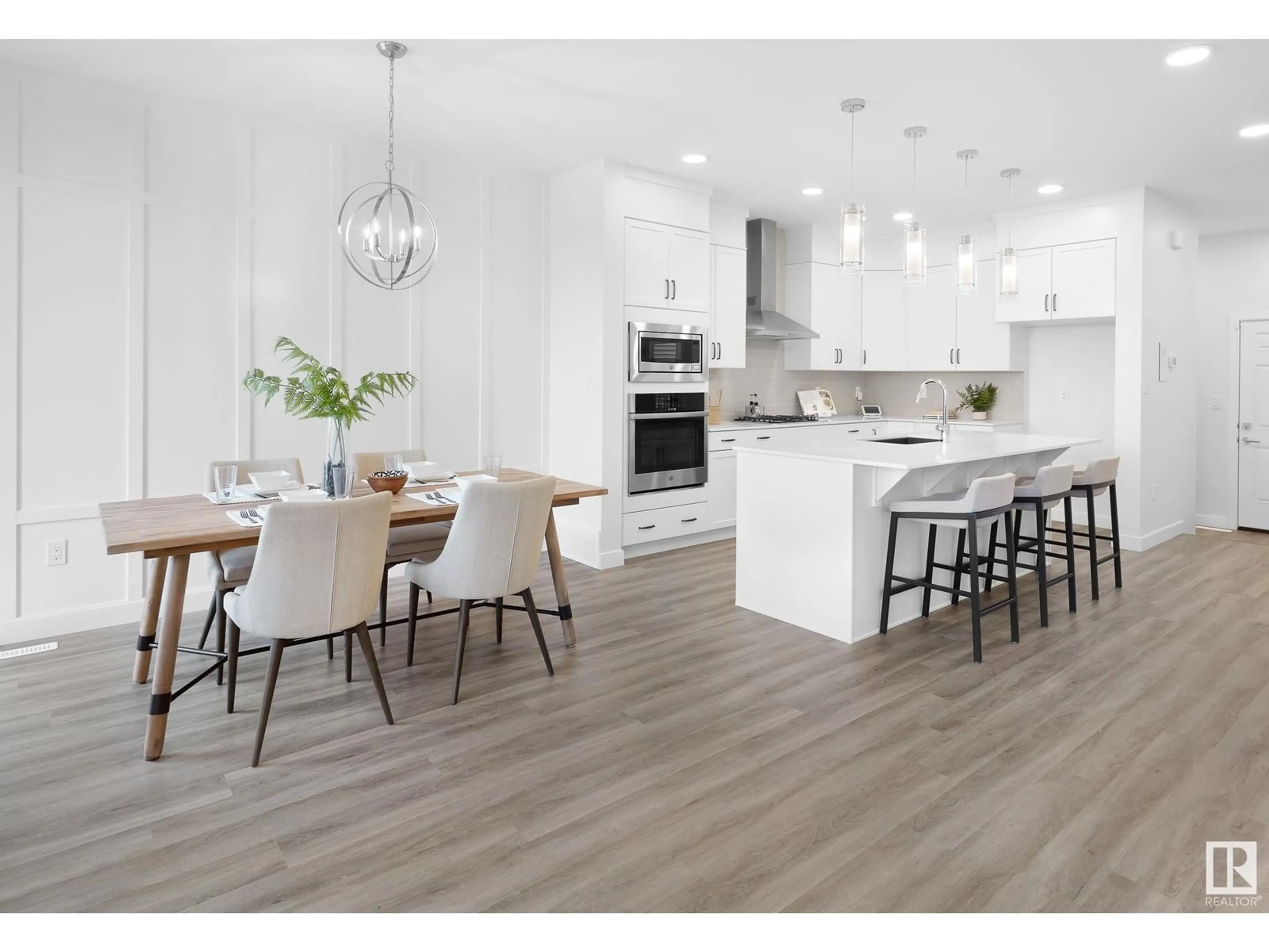 Open concept kitchen, wood/laminate floor for SW - 703 PAYIPWAT CM, Edmonton Alberta T6W5K8
