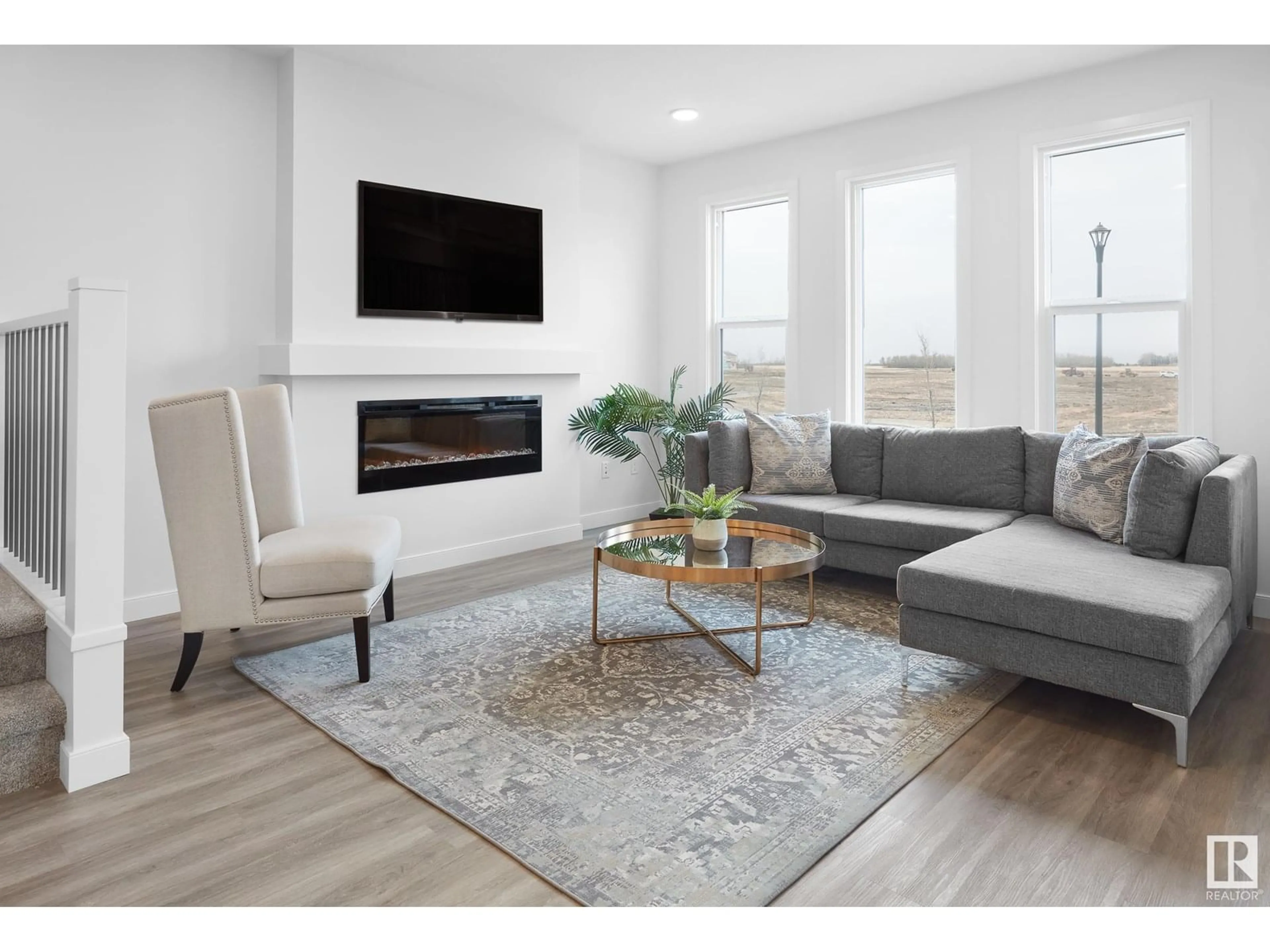 Living room with furniture, wood/laminate floor for SW - 703 PAYIPWAT CM, Edmonton Alberta T6W5K8