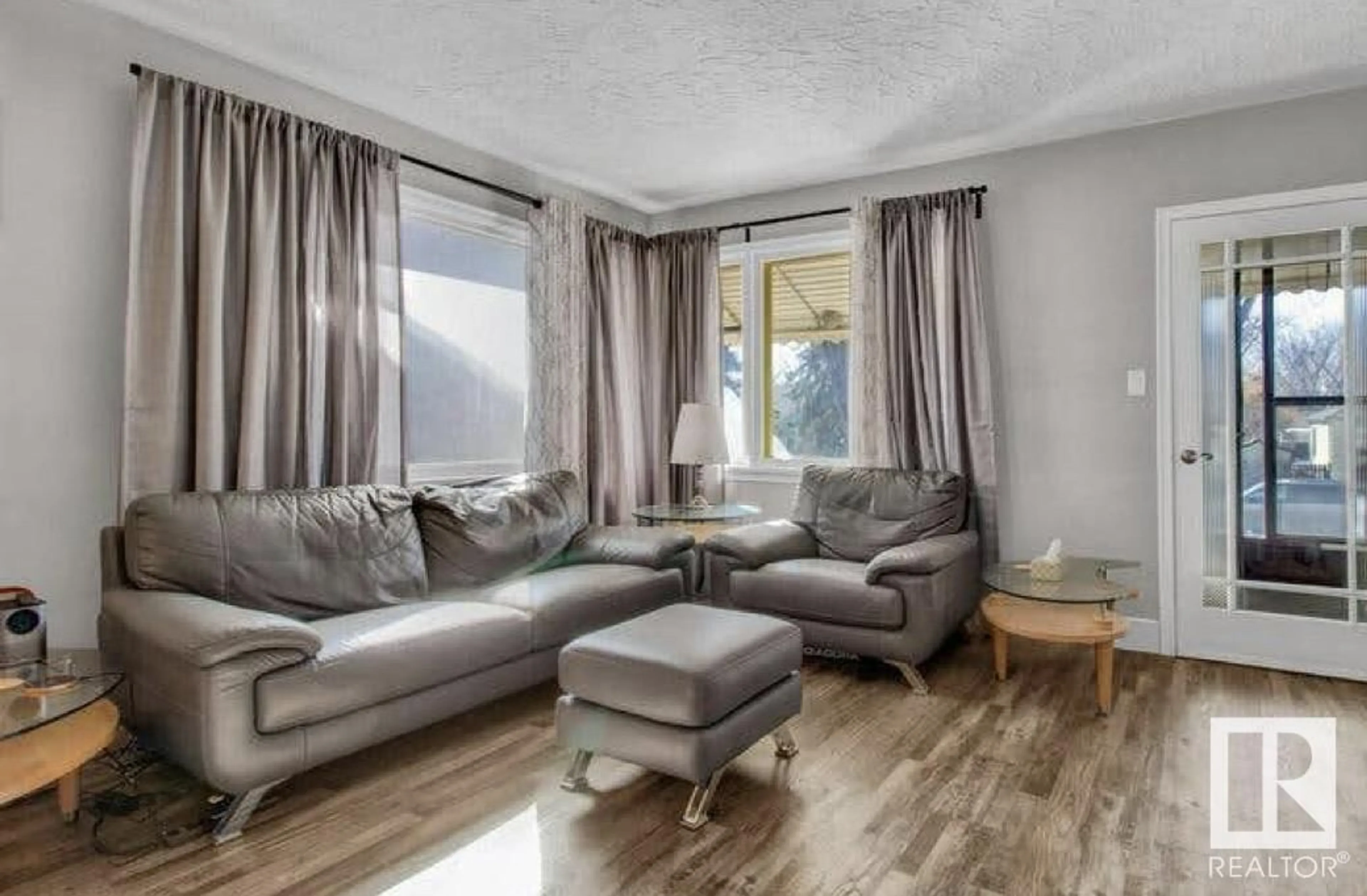 Living room with furniture, wood/laminate floor for NW - 11245 69 ST, Edmonton Alberta T5B1R6
