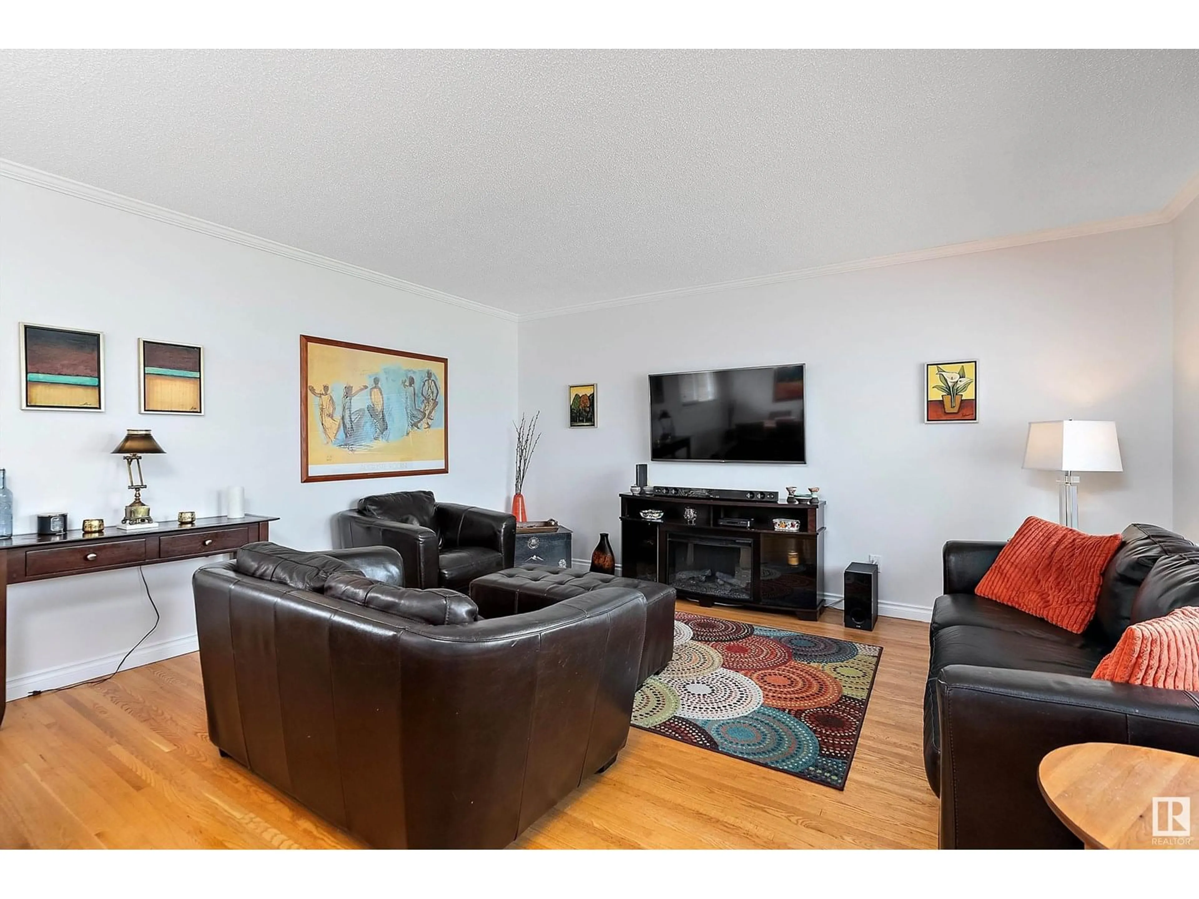 Living room with furniture, wood/laminate floor for 11127 43 AV, Edmonton Alberta T6J0X6