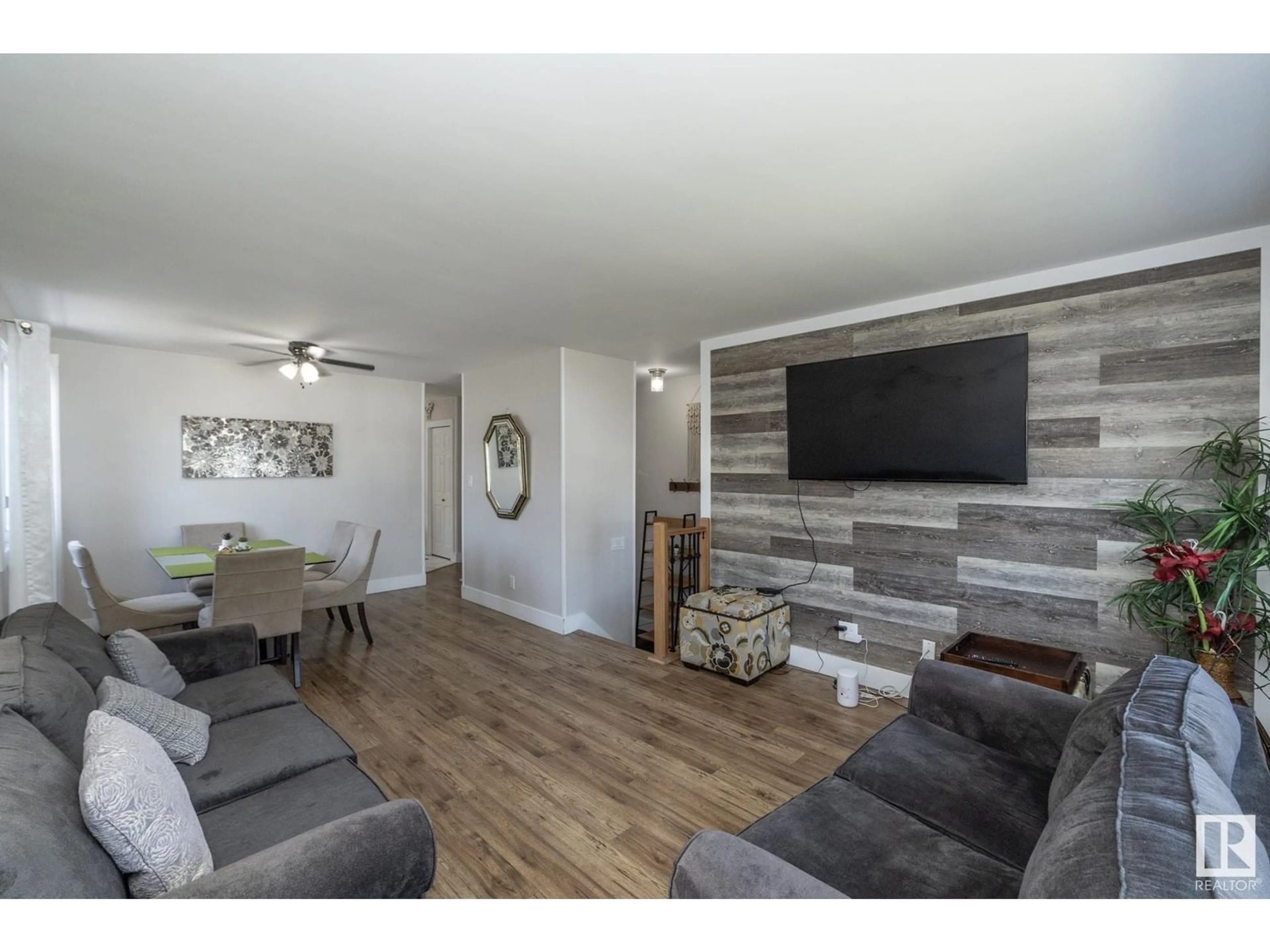 Living room with furniture, wood/laminate floor for 3511 33 AV, Edmonton Alberta T6L4N6