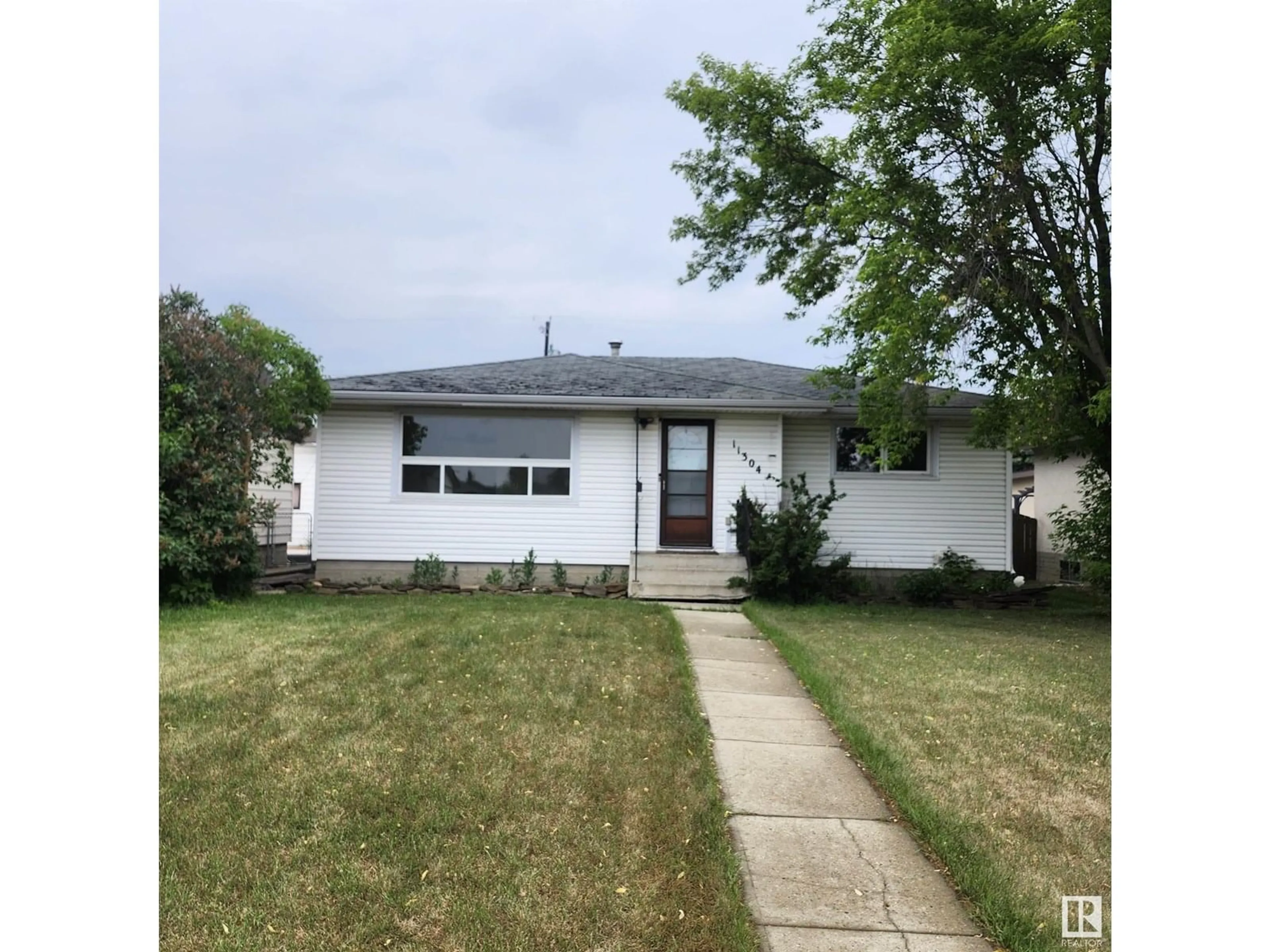 Home with vinyl exterior material, street for 11304 136 AV, Edmonton Alberta T5E1X1