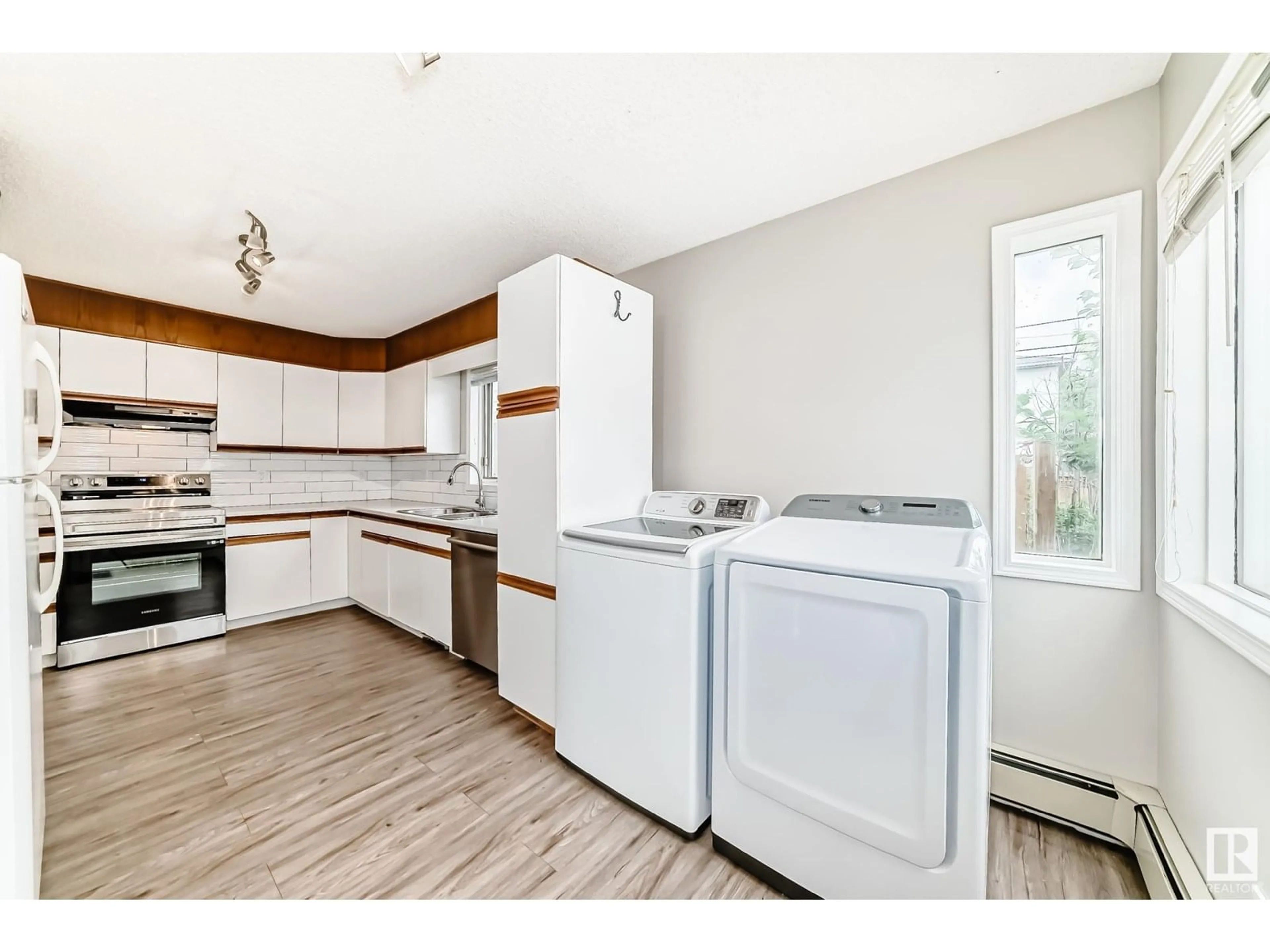 Kitchen with laundary machines, wood/laminate floor for 10735 68 AV, Edmonton Alberta T6H2B6