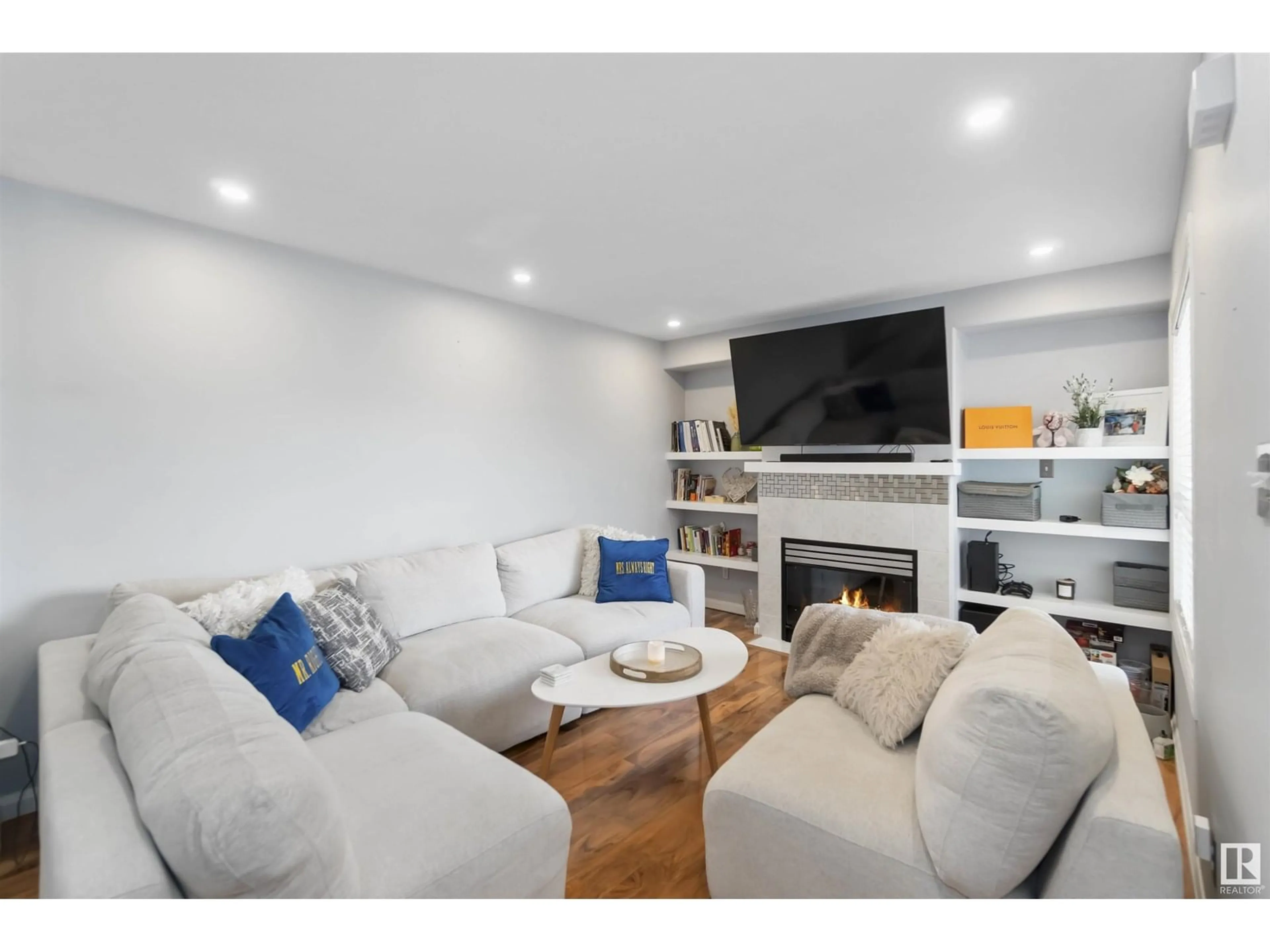 Living room with furniture, wood/laminate floor for 8203 - 11 160 AV, Edmonton Alberta T5Z3C1