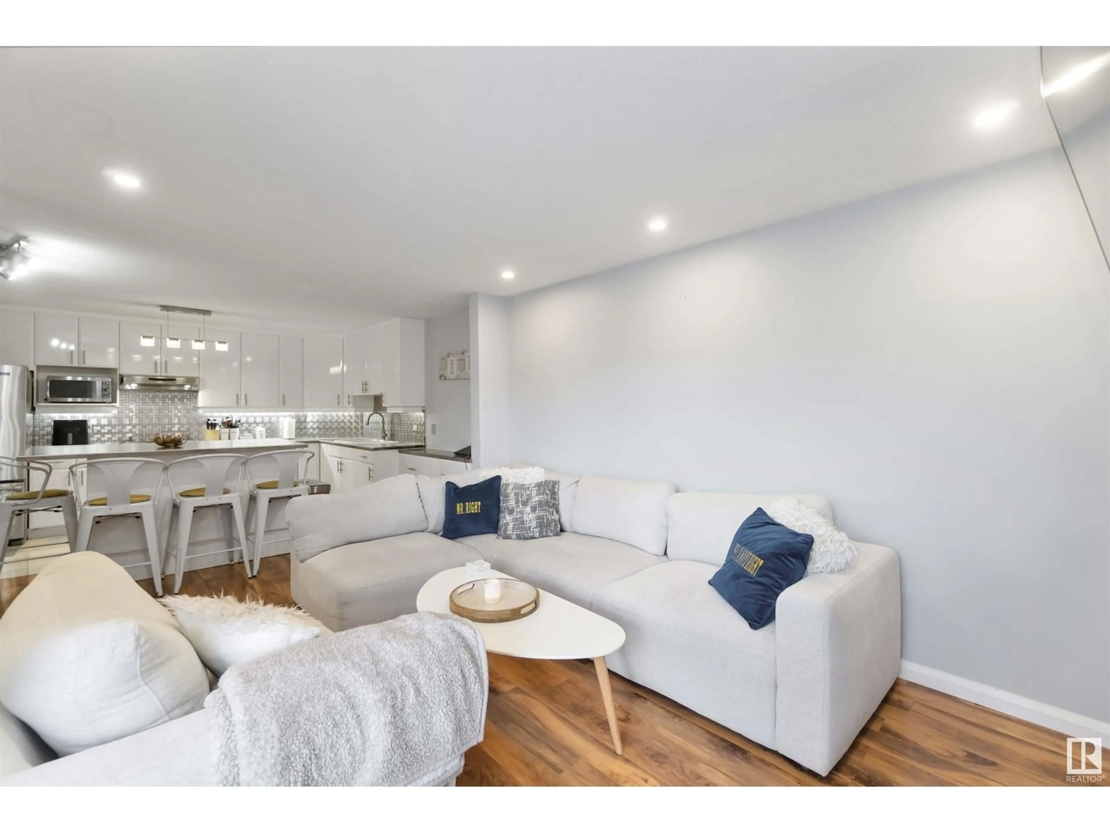 Living room with furniture, wood/laminate floor for 8203 - 11 160 AV, Edmonton Alberta T5Z3C1