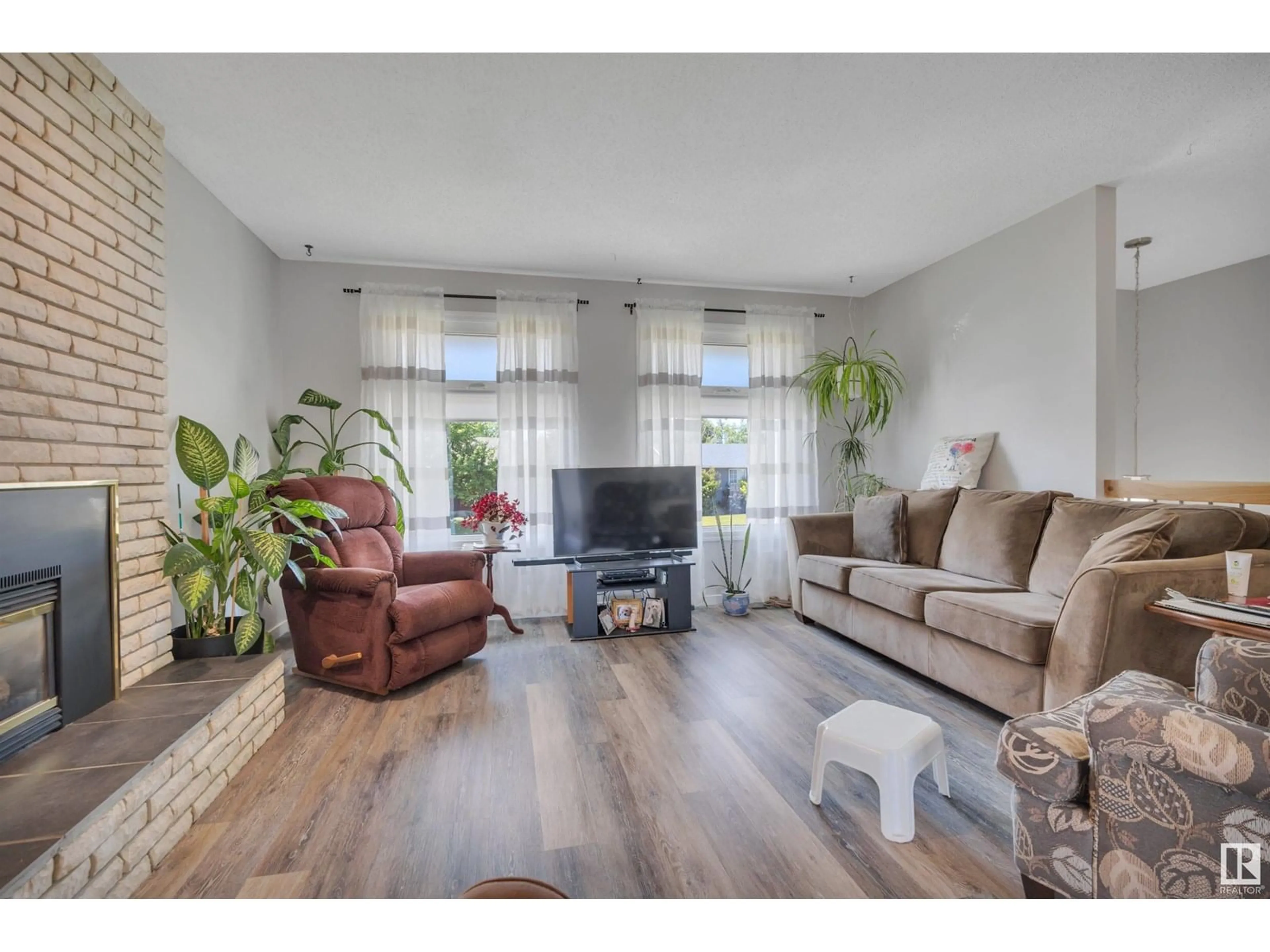 Living room with furniture, wood/laminate floor for NW - 13527 27 ST, Edmonton Alberta T5A3W7