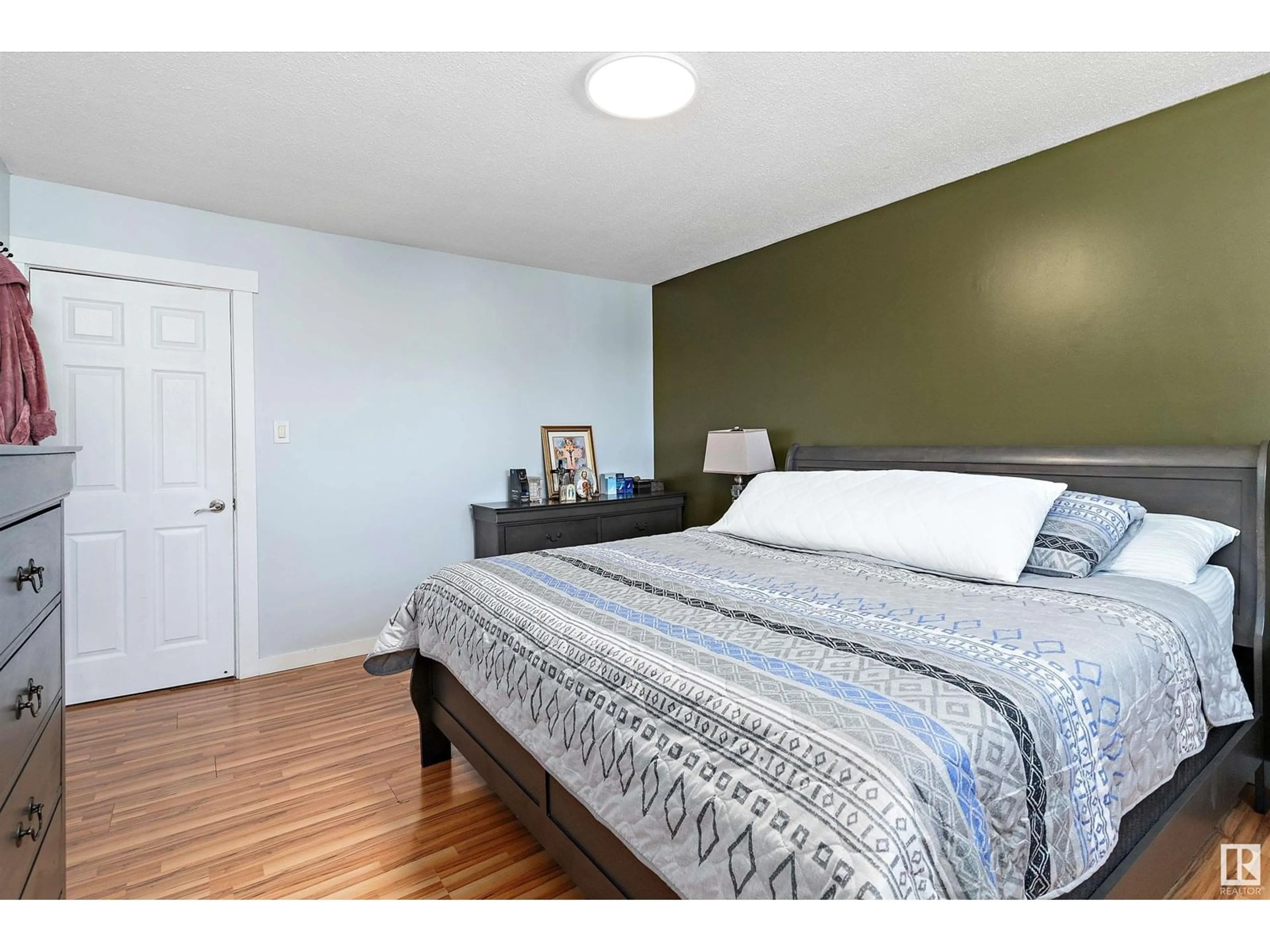 Bedroom with bed, wood/laminate floor for NW - 17315 78 AV, Edmonton Alberta T5T0A8