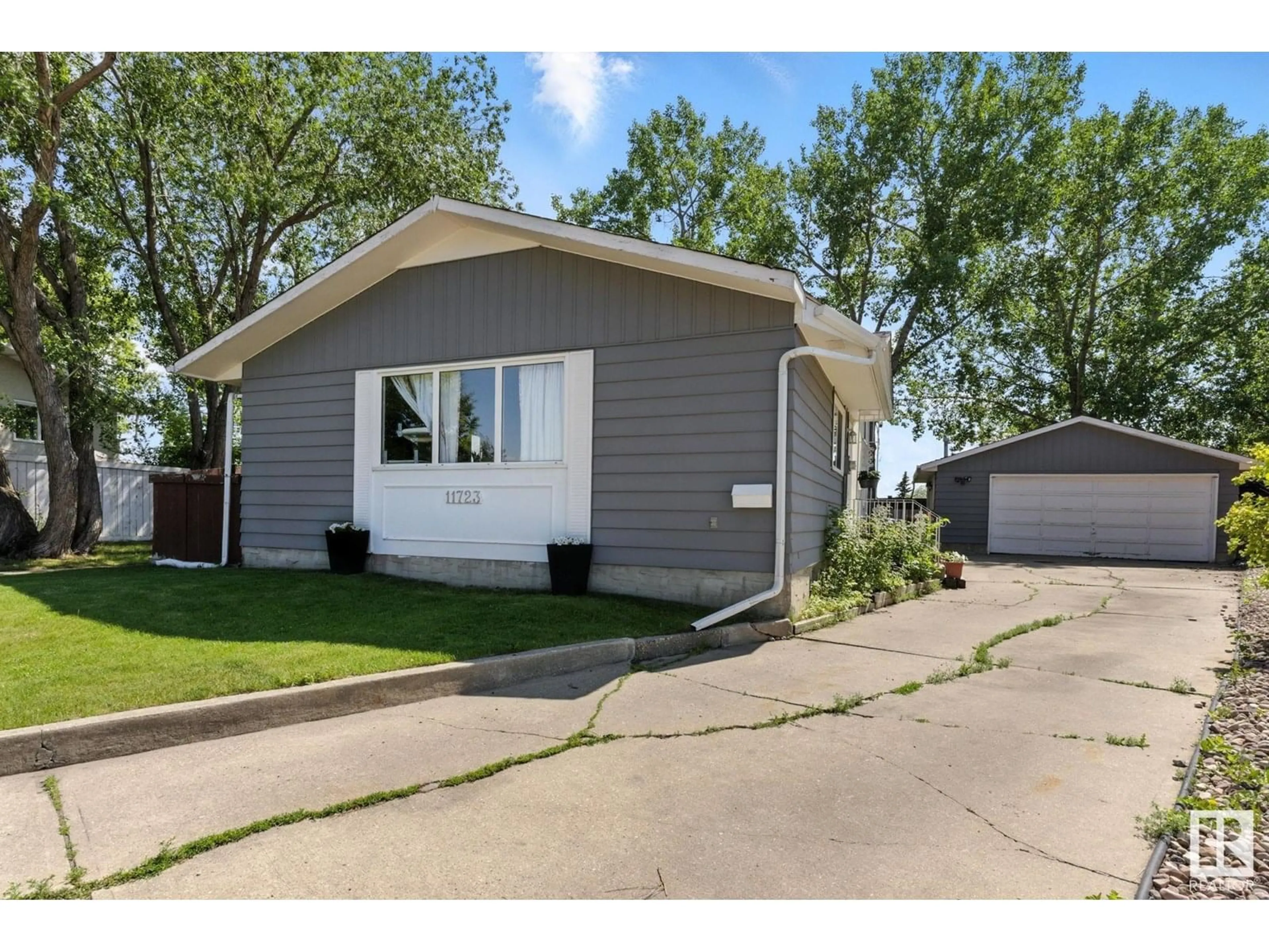 Home with vinyl exterior material, street for 11723 144 AV, Edmonton Alberta T5X1M4