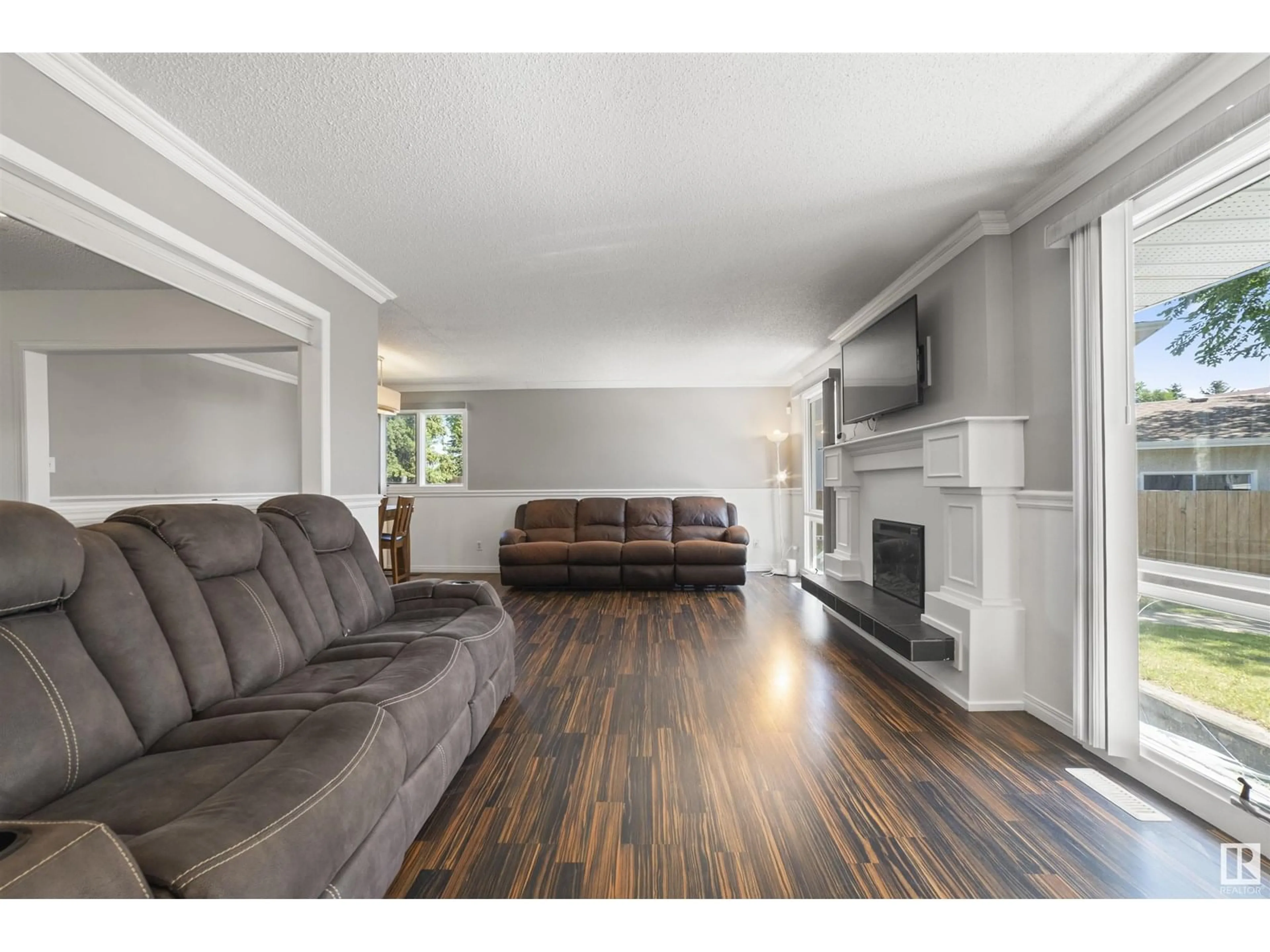 Living room with furniture, wood/laminate floor for 2727 83 STREET, Edmonton Alberta T6K3G7