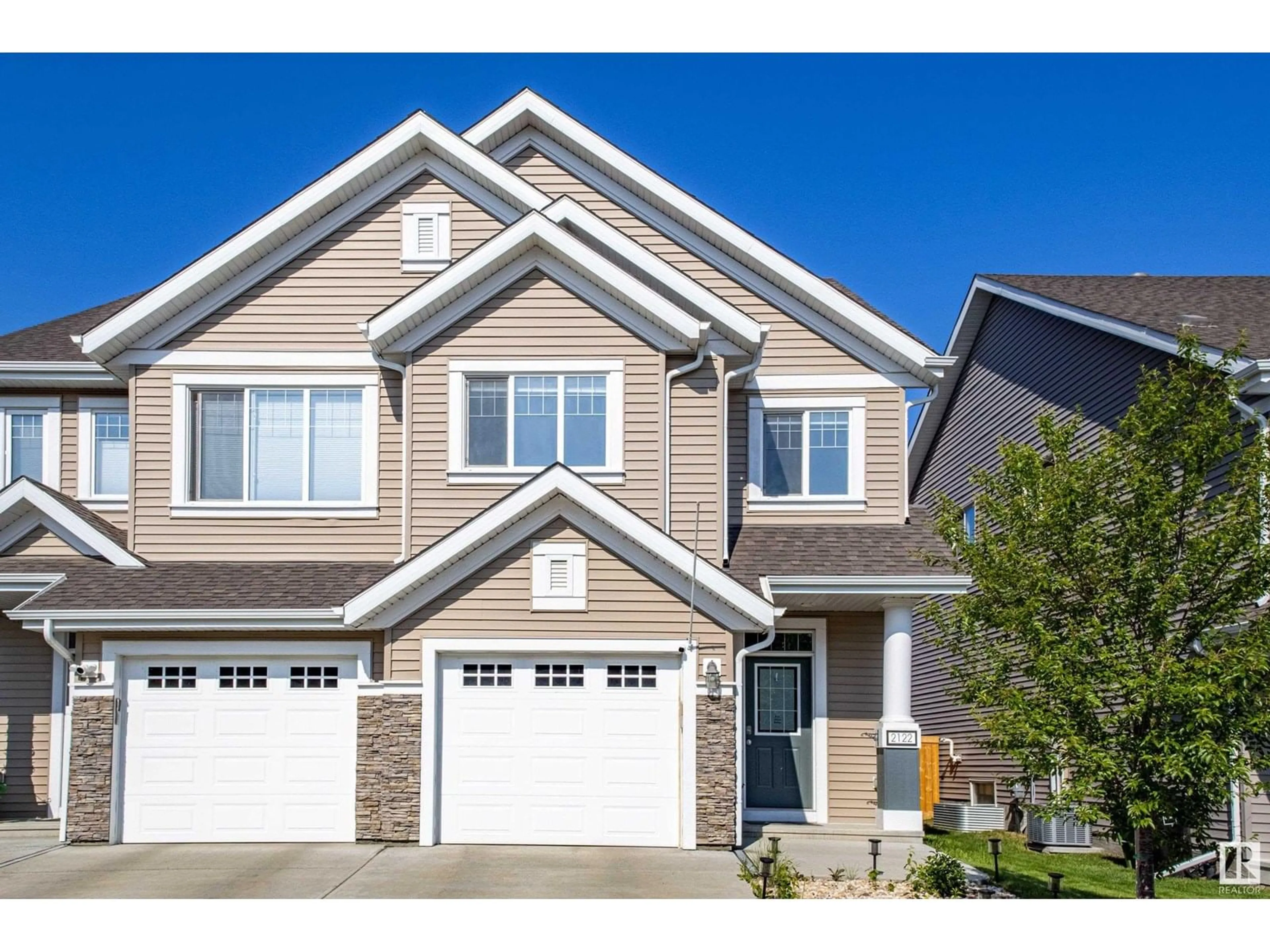Home with vinyl exterior material, street for 2122 85 ST, Edmonton Alberta T6X2J5