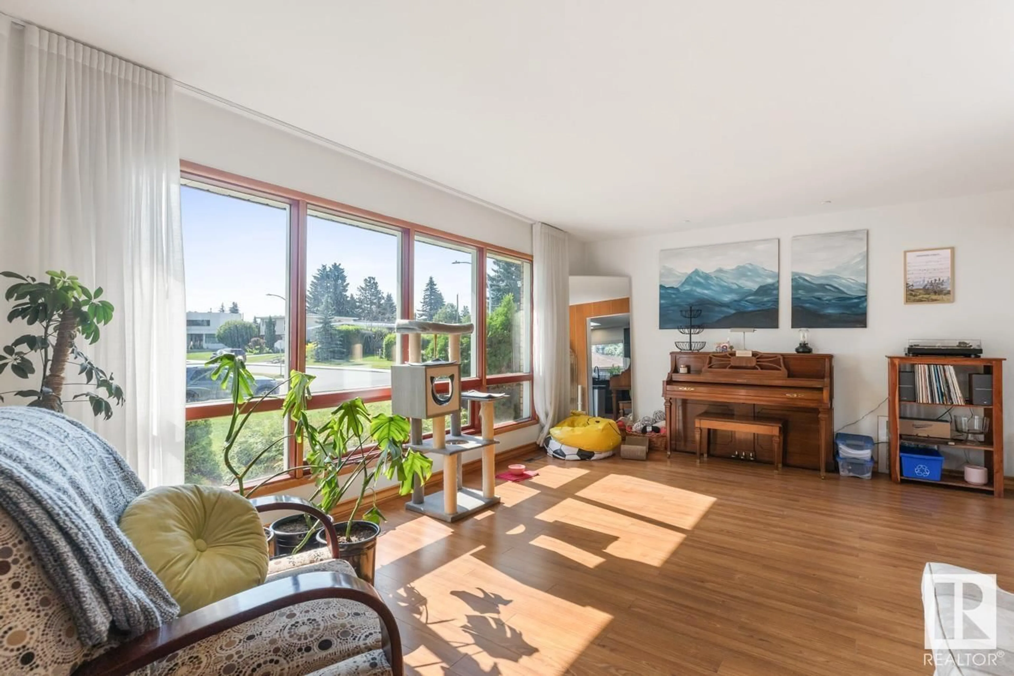 Living room with furniture, wood/laminate floor for 9208 71 ST, Edmonton Alberta T6B1Y2