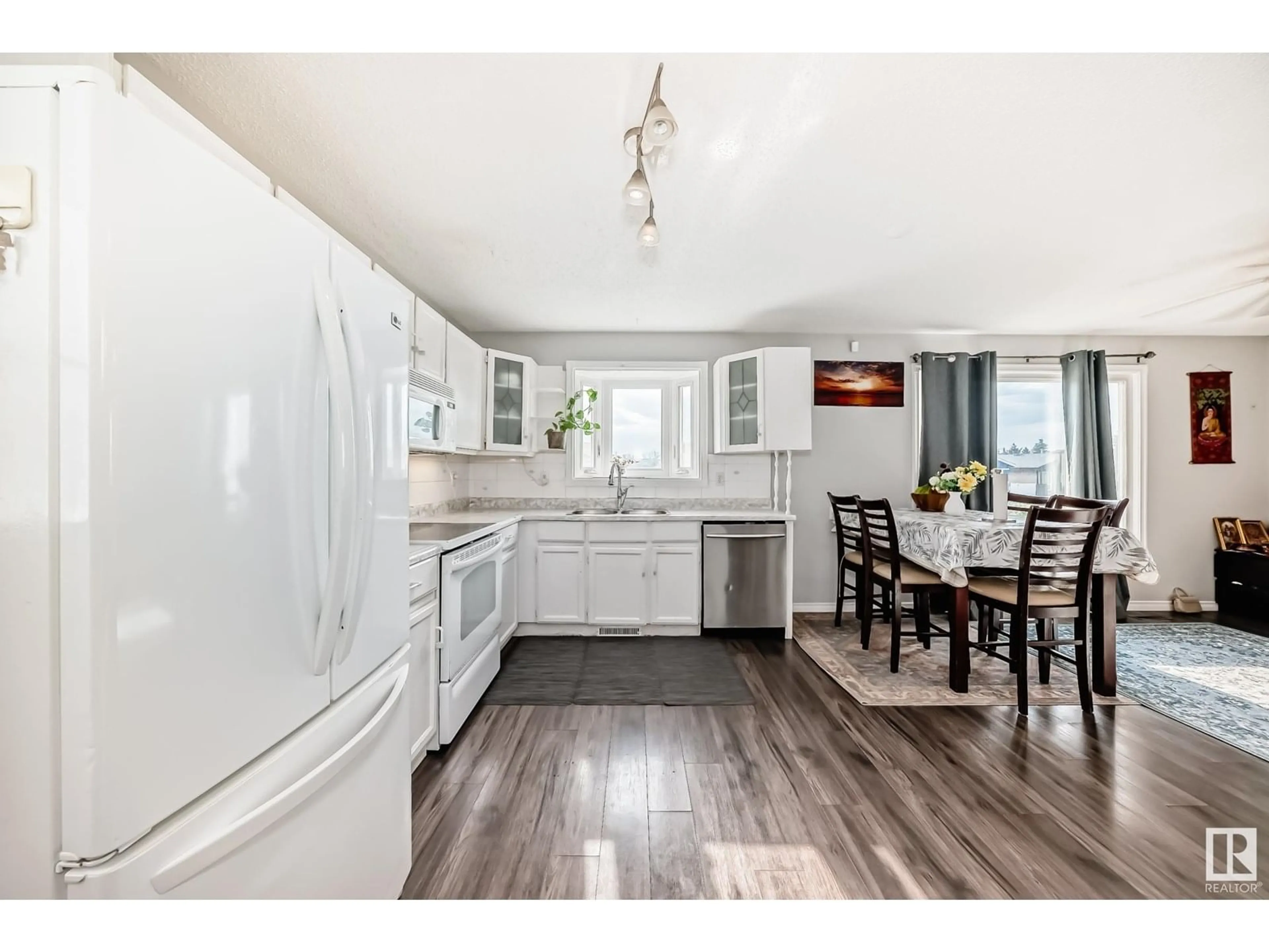 Open concept kitchen, wood/laminate floor for 3312 44A ST, Edmonton Alberta T6L4W9