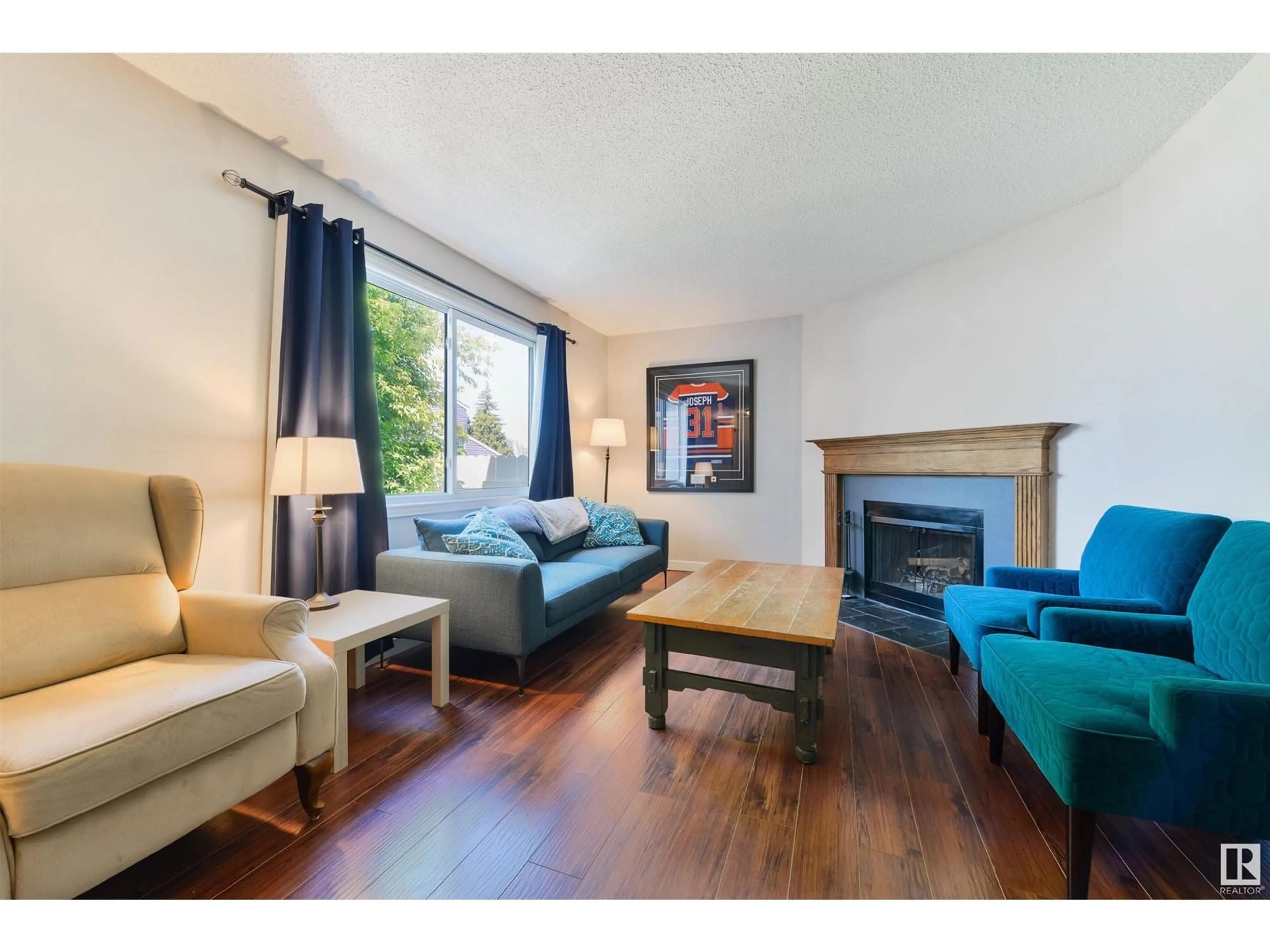 Living room with furniture, wood/laminate floor for #109 - 14707 53 AV, Edmonton Alberta T6H5C9