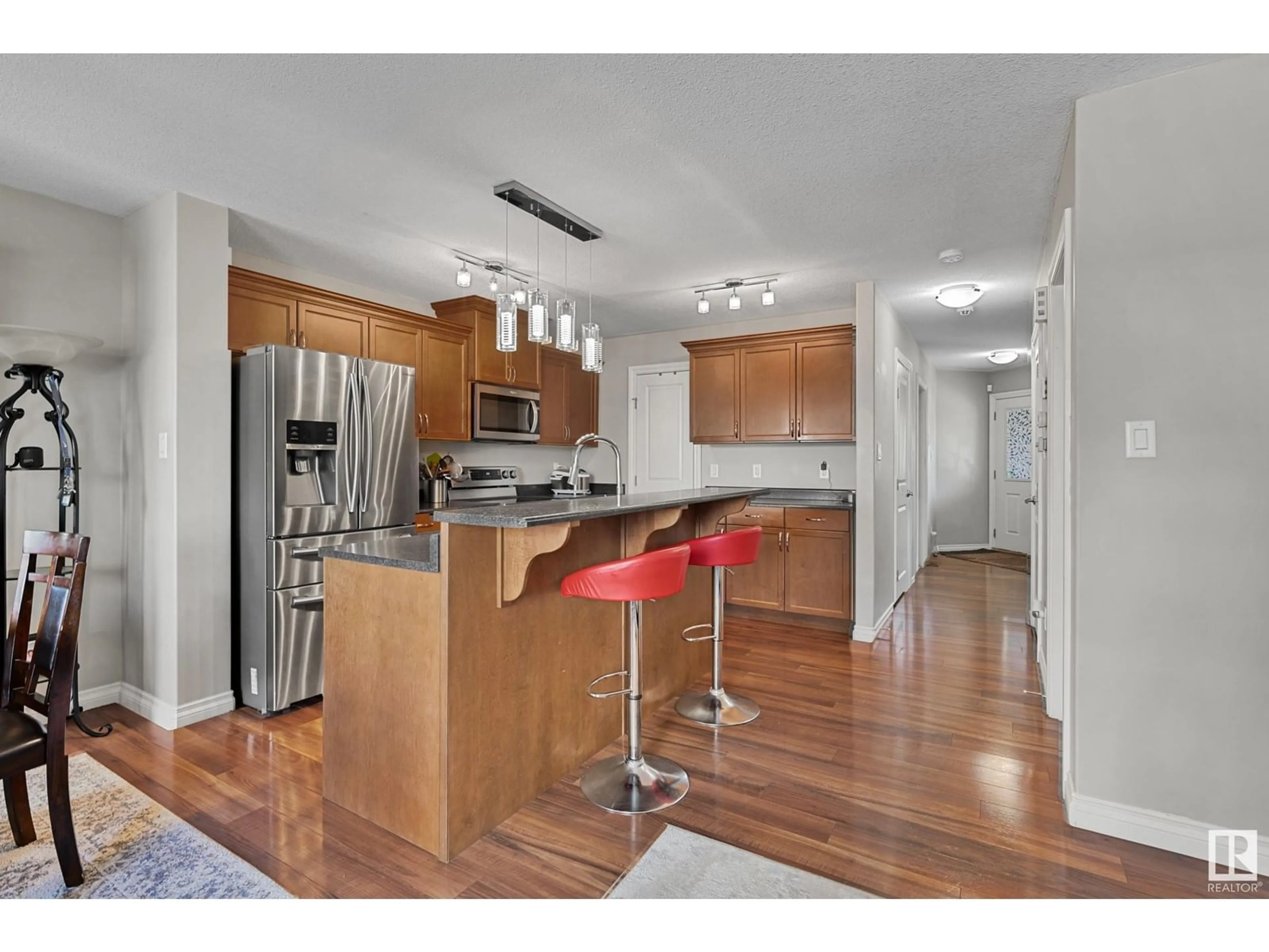 Open concept kitchen, wood/laminate floor for 21914 91 AV, Edmonton Alberta T5T6Z5
