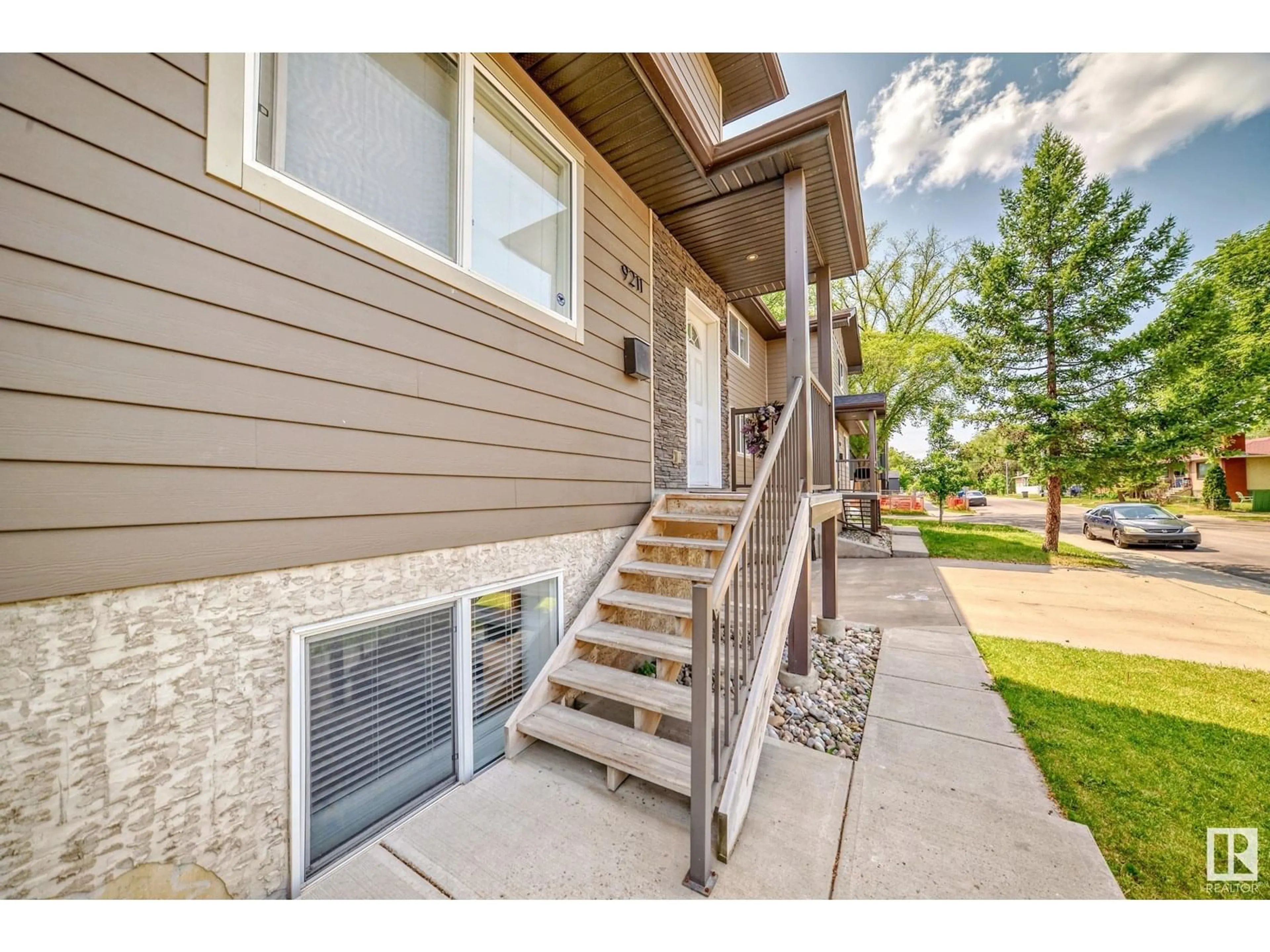 Home with vinyl exterior material, street for 9211 123 AV, Edmonton Alberta T5G0R1