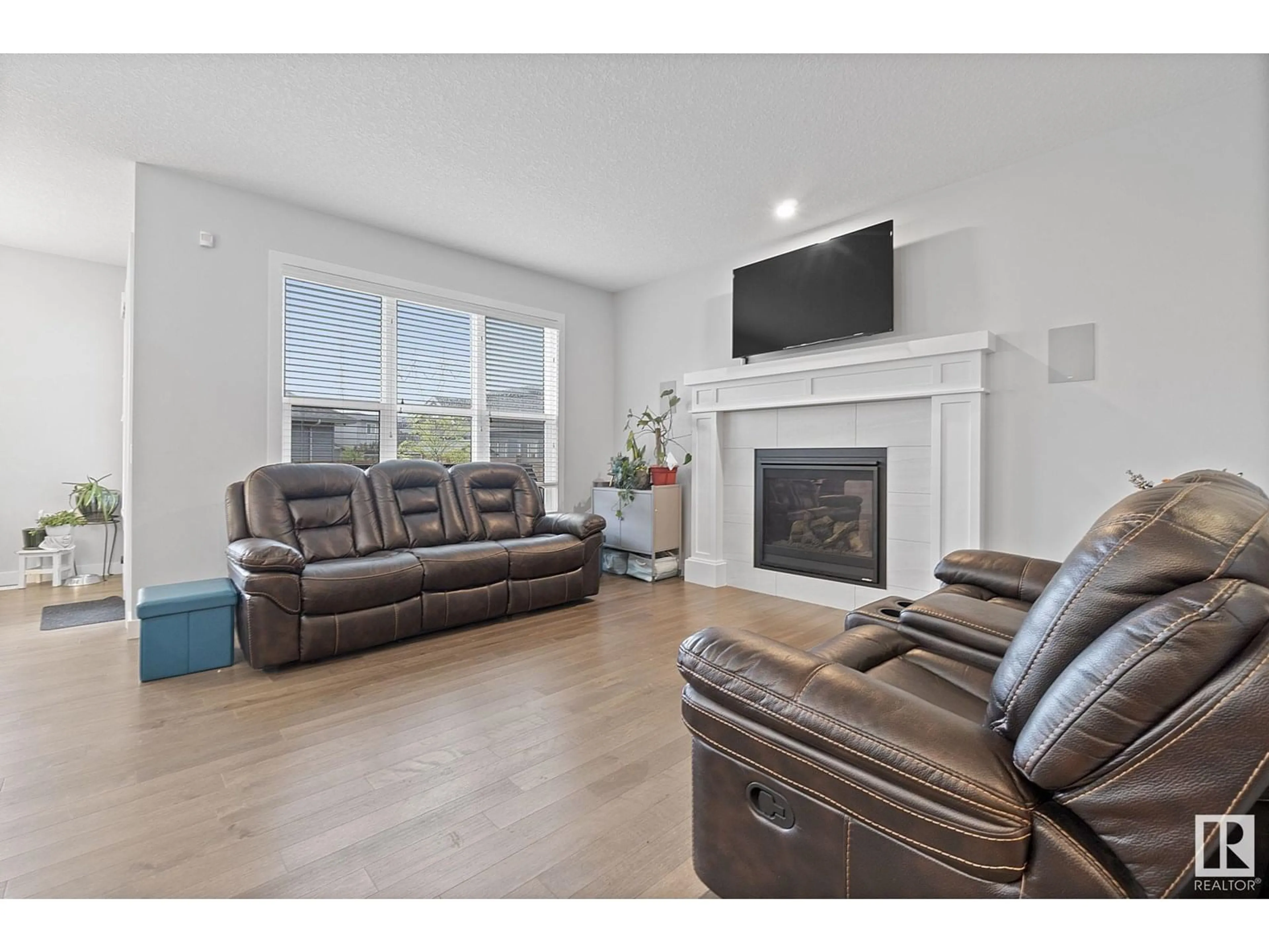 Living room with furniture, wood/laminate floor for NW - 2839 202 ST, Edmonton Alberta T6M0W6
