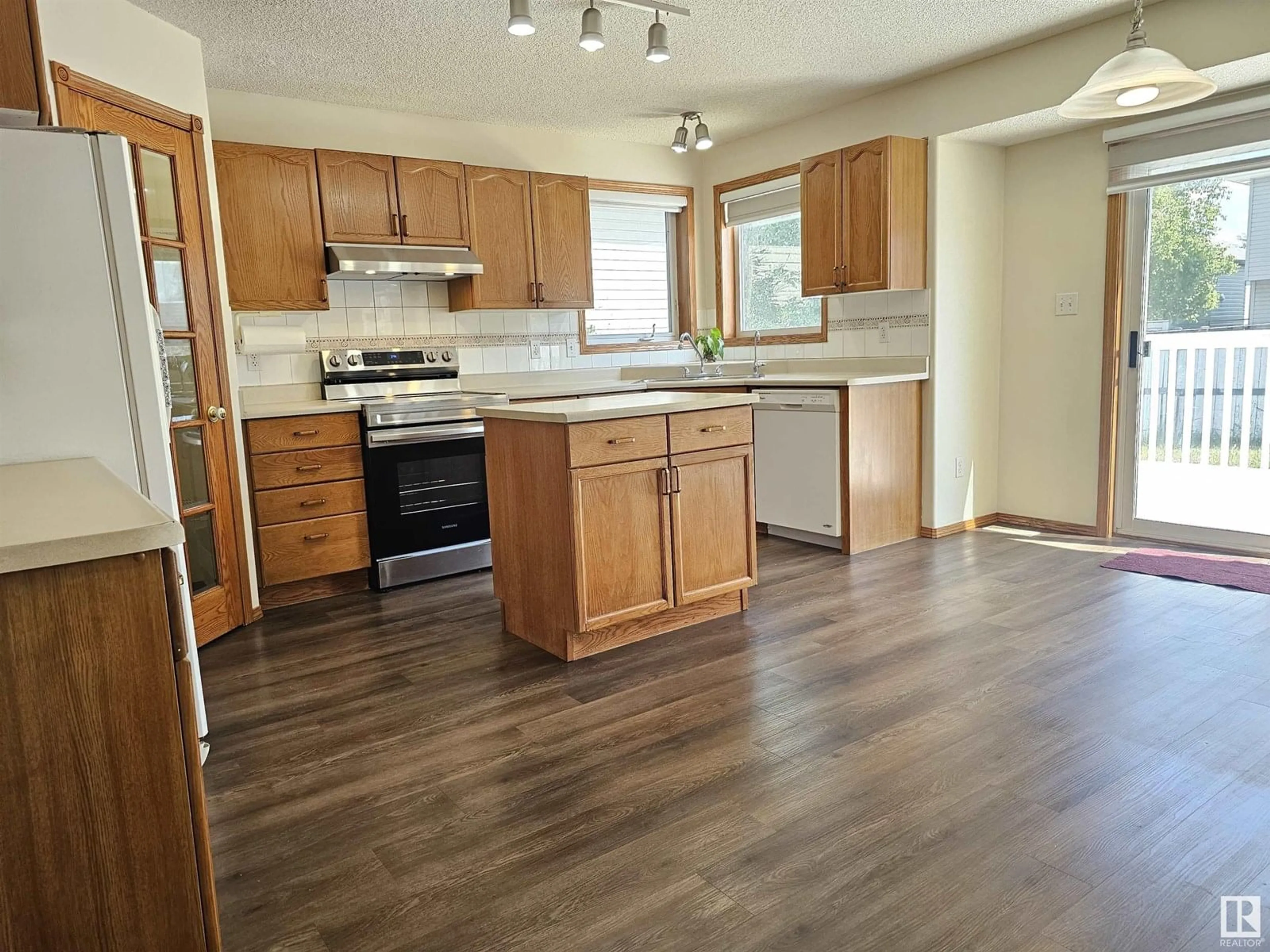 Open concept kitchen, wood/laminate floor for NW - 2331 37B AV, Edmonton Alberta T6T1N9