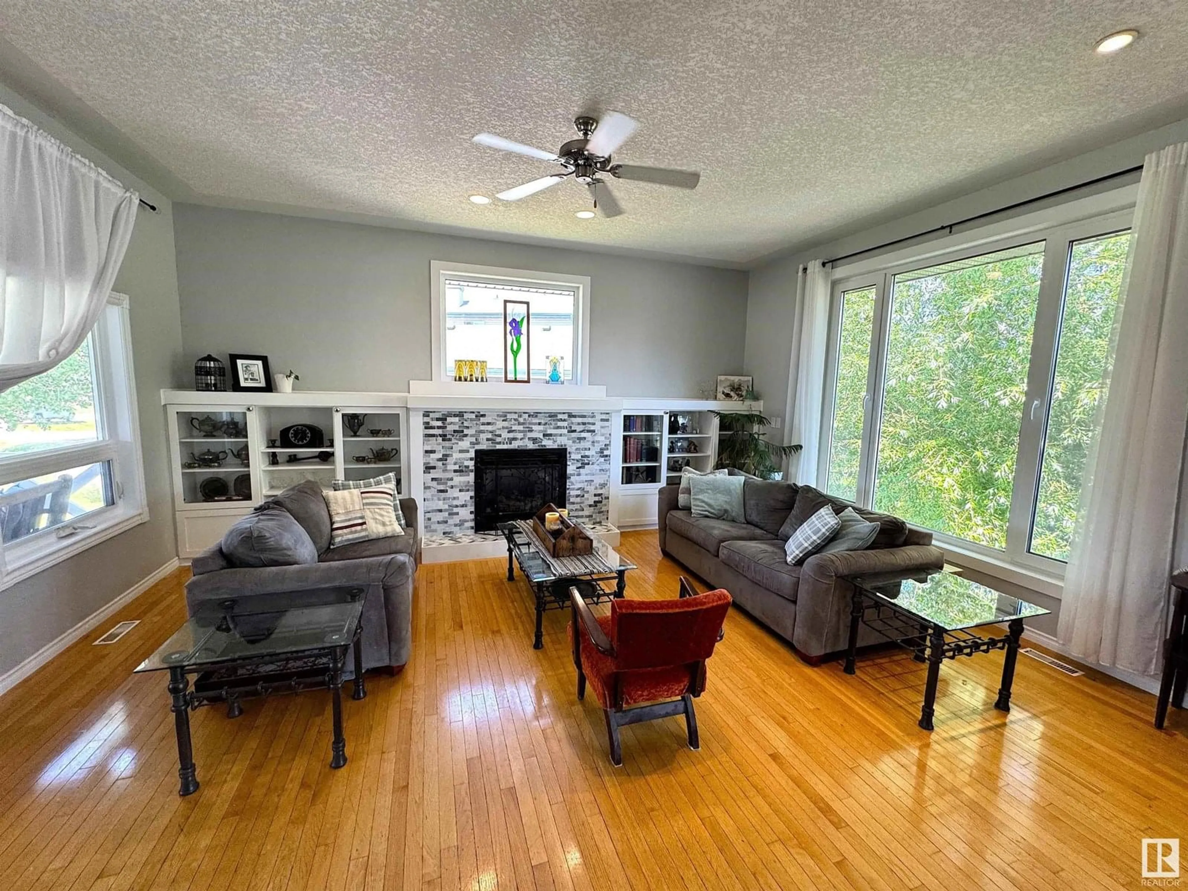 Living room with furniture, wood/laminate floor for #302 - 53302 RANGE ROAD 261, Rural Parkland County Alberta T7Y1A7