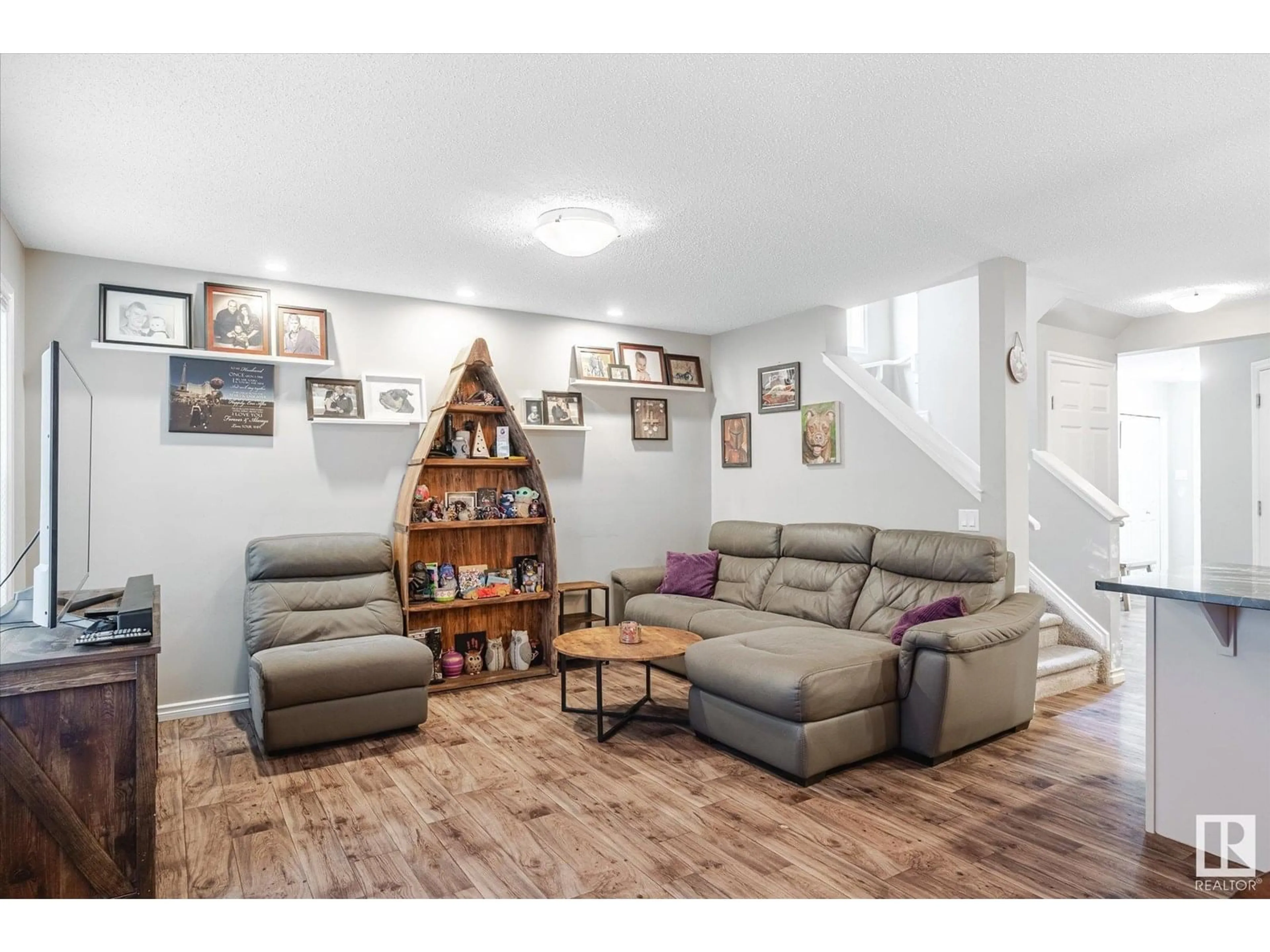 Living room with furniture, wood/laminate floor for NW - 2424 19A AV, Edmonton Alberta T6T2C9